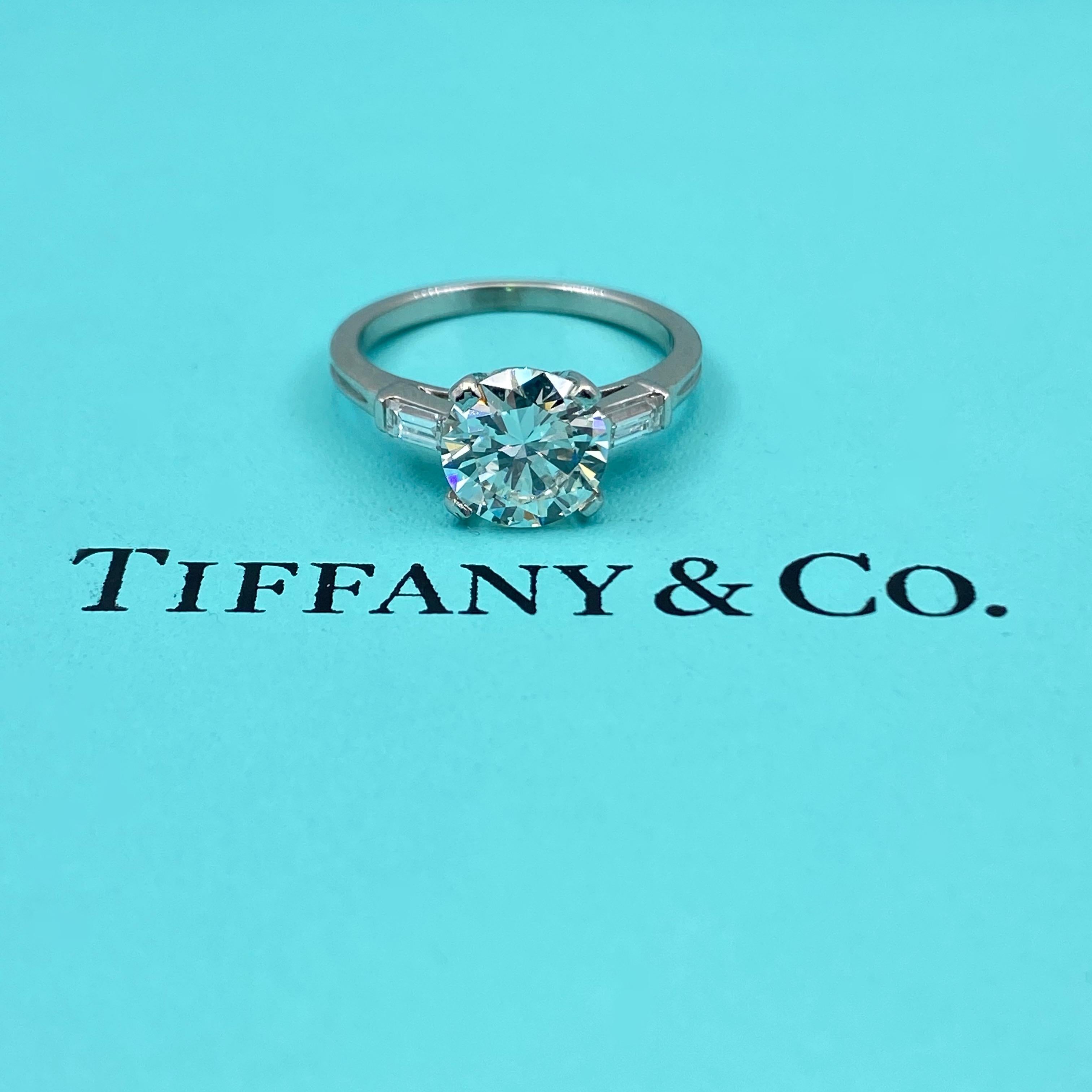 Vintage Tiffany & Company Diamond Ring
Style:  Classic 1950's Tiffany Engagement Ring
Metal:  Platinum 
Size / Measurements:  5, sizable
TCW:  1.72 Carats Total
Main Diamond:  1.52 Round Brilliant Cut
Color & Clarity:  H Color,  VS2 Clarity
Accent