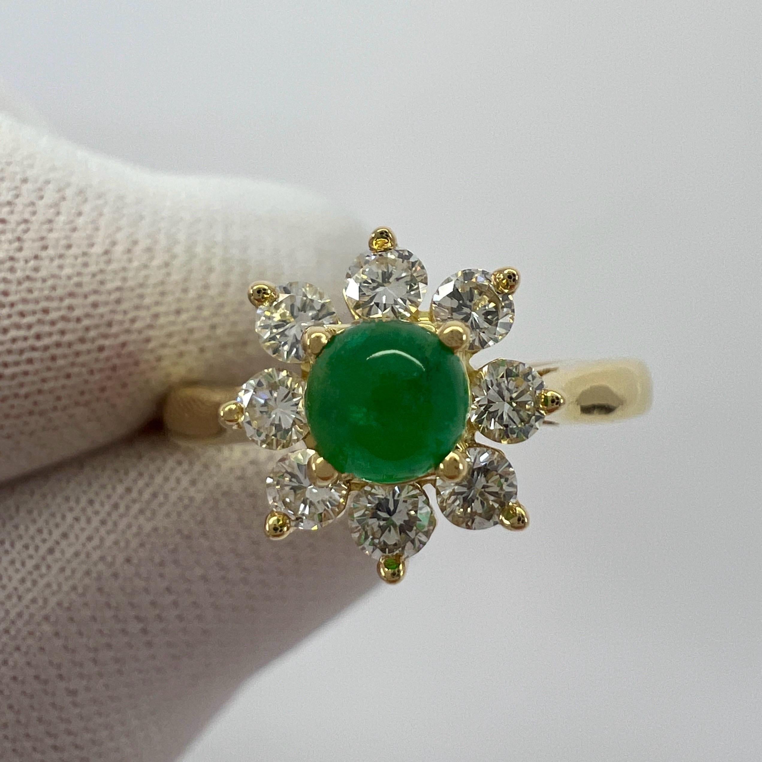 Vintage Tiffany & Co. Natural Round Cabochon Emerald And Diamond 18k Yellow Gold Flower 'Buttercup' Ring.

A beautifully made yellow gold cluster ring set with a stunning 4.2 mm round cabochon cut natural emerald centre stone. Superb colour with