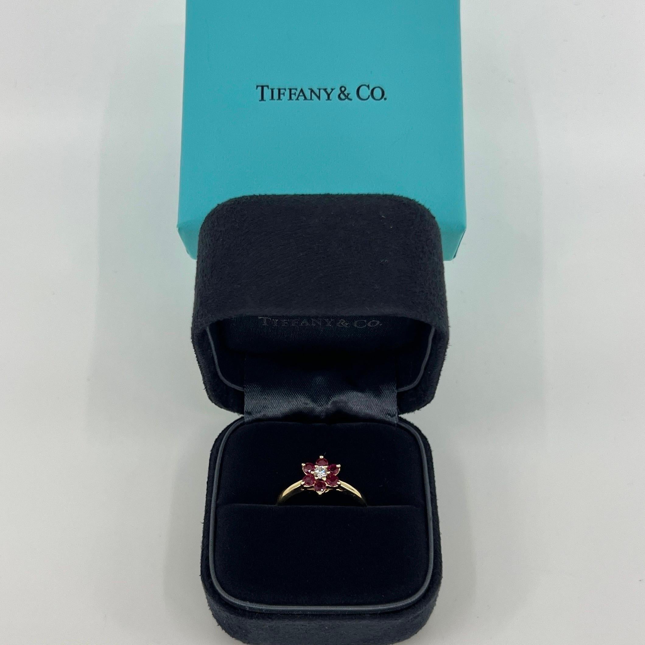 Vintage Tiffany & Co. Bague à fleur en or jaune 18k avec rubis et diamants.

Bague en or jaune magnifiquement réalisée, sertie d'un diamant blanc de 2,8 mm au centre, de pureté VS, de couleur F/G et d'une excellente taille ronde de brillant.
Il est