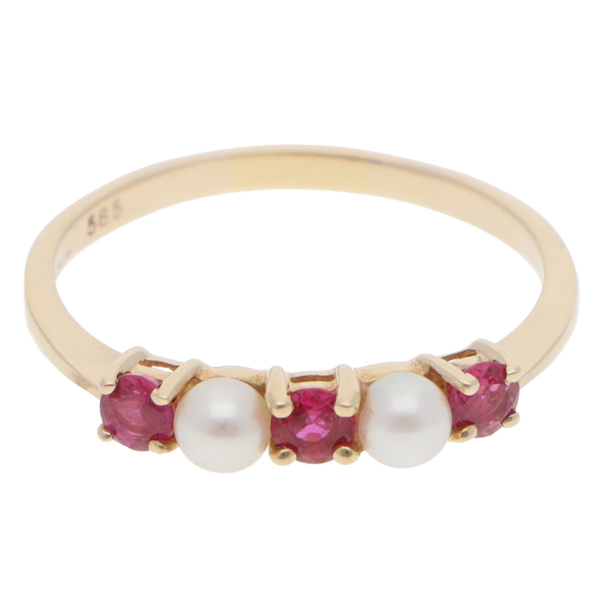 A beautiful vintage Tiffany & Co. ruby and pearl ring set in 14k yellow gold.

The ring is composed of 3 round mixed-cut vibrant rubies, four-prong set securely with 2 pearls. This ring is perfect for everyday wear. It looks great alone or alongside