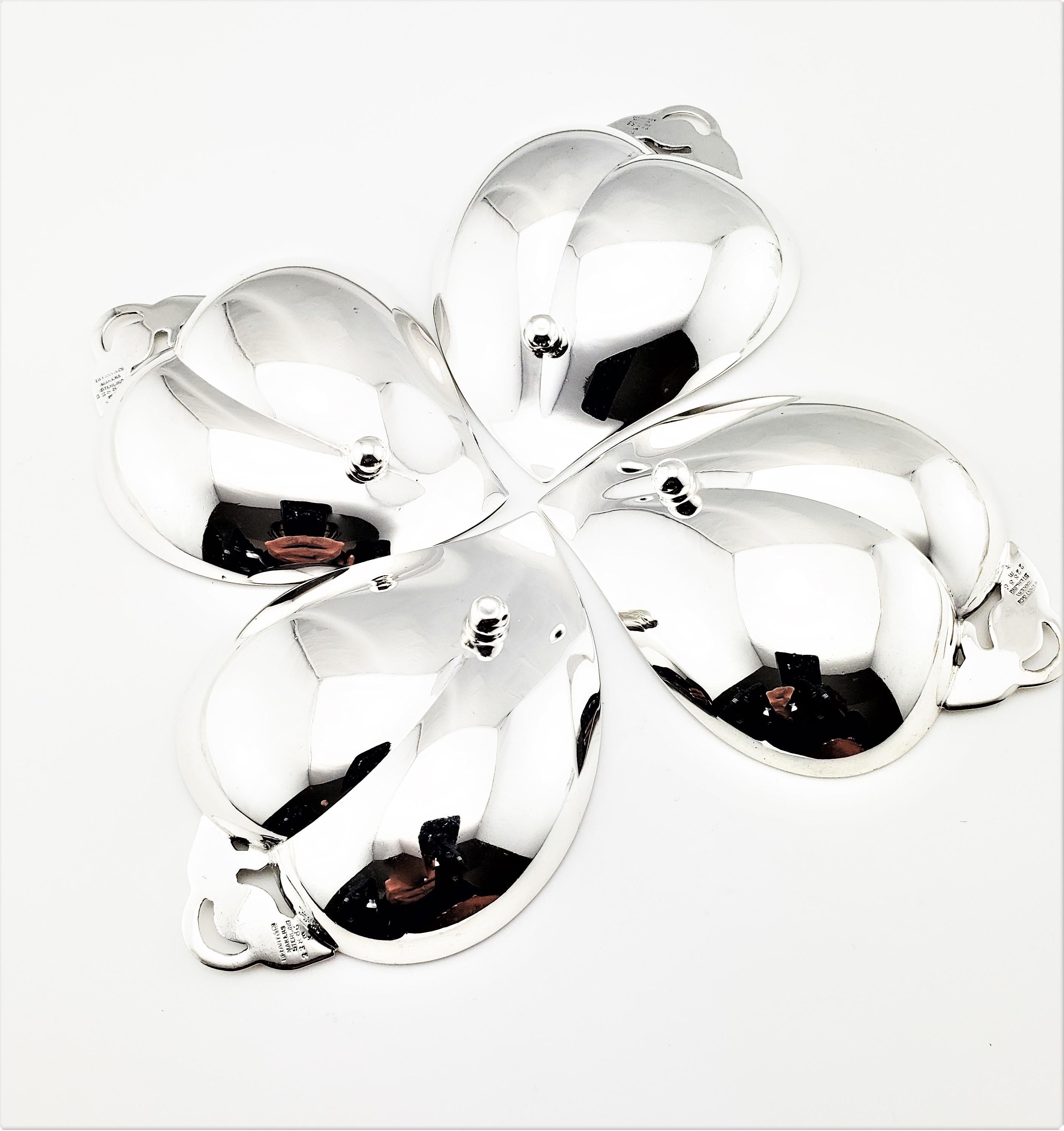 Vintage Tiffany & Co. set of 4 sterling silver candy or nut leaf dishes-

This set of four sterling silver serving dishes are crafted in a beautiful leaf design by Tiffany & Co.

Size: 3 1/4