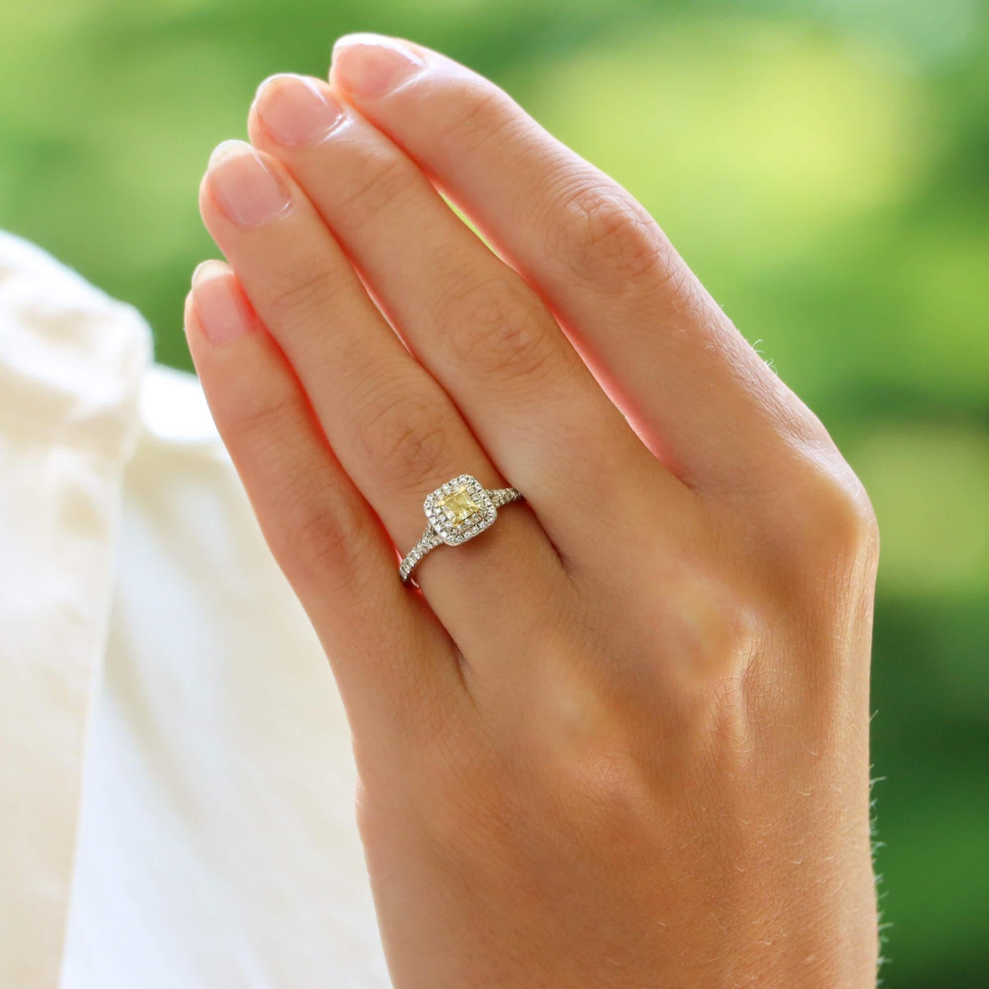 A beautiful vintage Tiffany & Co. Soleste cushion cut yellow diamond double halo ring set in platinum.

The ring is centrally set with a sparkly 0.28 carat cushion cut yellow diamond which is four-claw set securely. Surrounding this central diamond