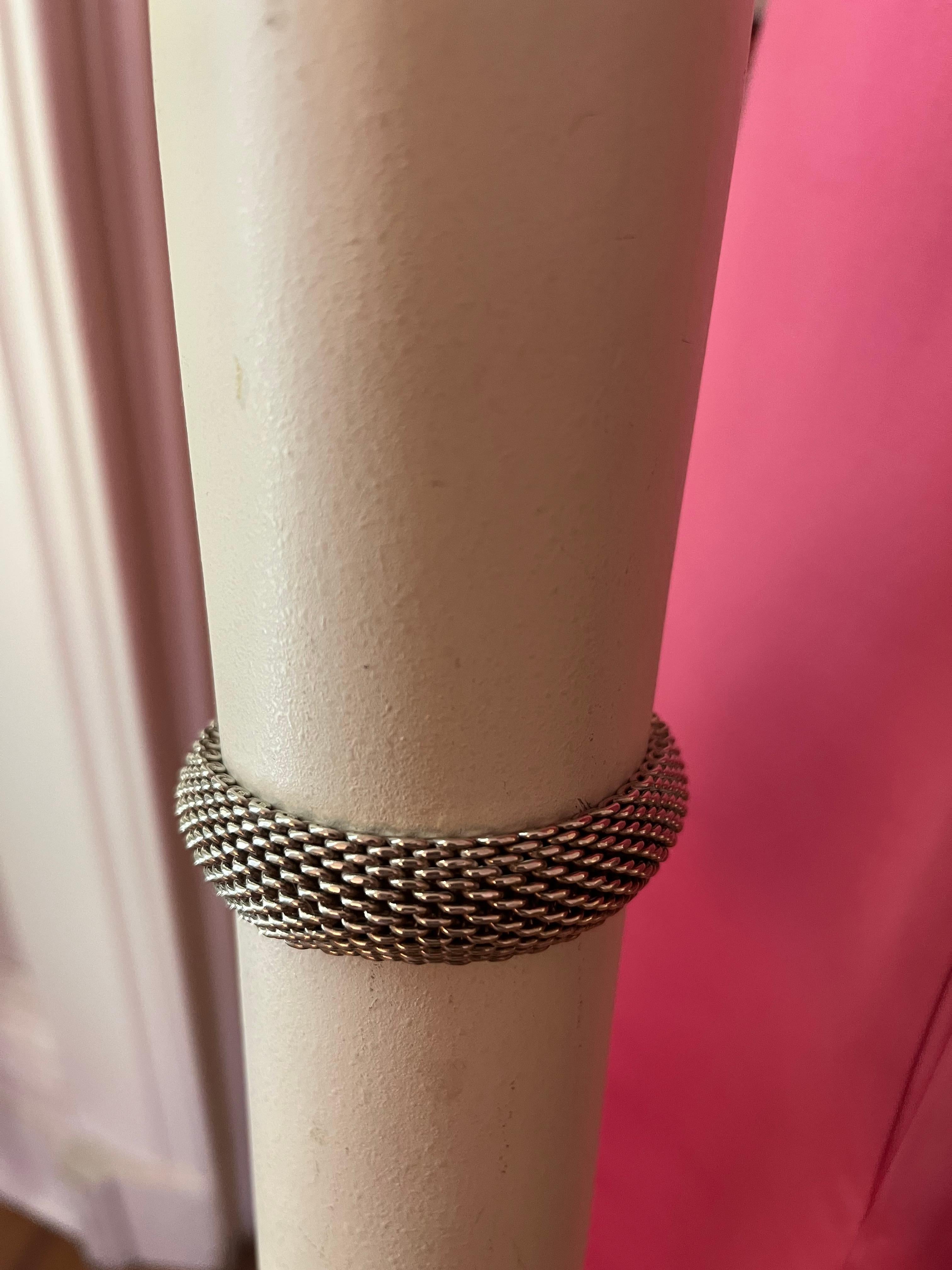 Beautiful vintage Tiffany & Co. Somerset .925 sterling silver mesh bangle. The workmanship is amazing, and presents a distinctive mesh design.  
The inside nameplate reads 