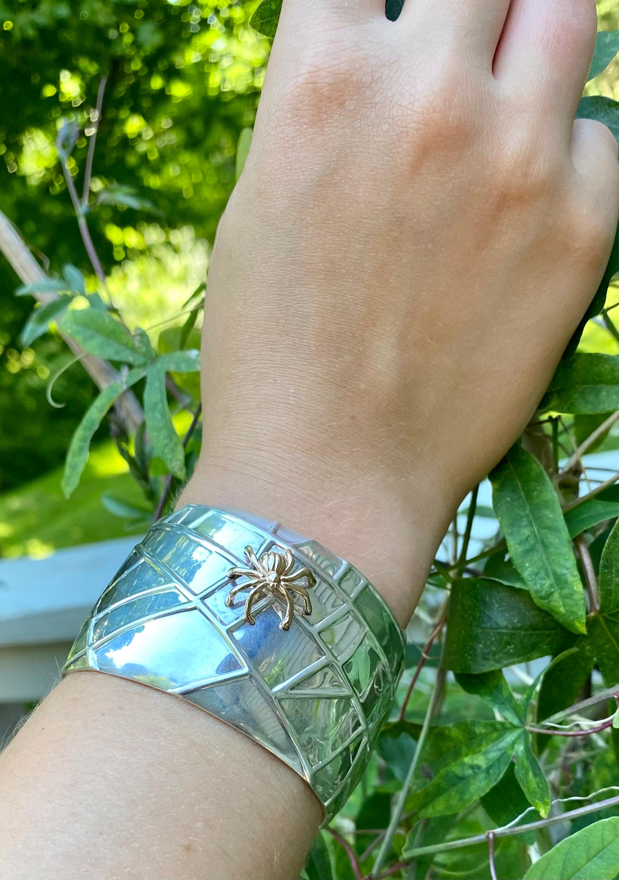 Dramatic statement Spider cuff bracelet by Tiffany & Co. in Sterling silver and 18K yellow gold 
Timeless organic motif modelled as a striking stylized sterling silver web with an 18K yellow gold spider in high relief.
Circa 2001
Fully signed and