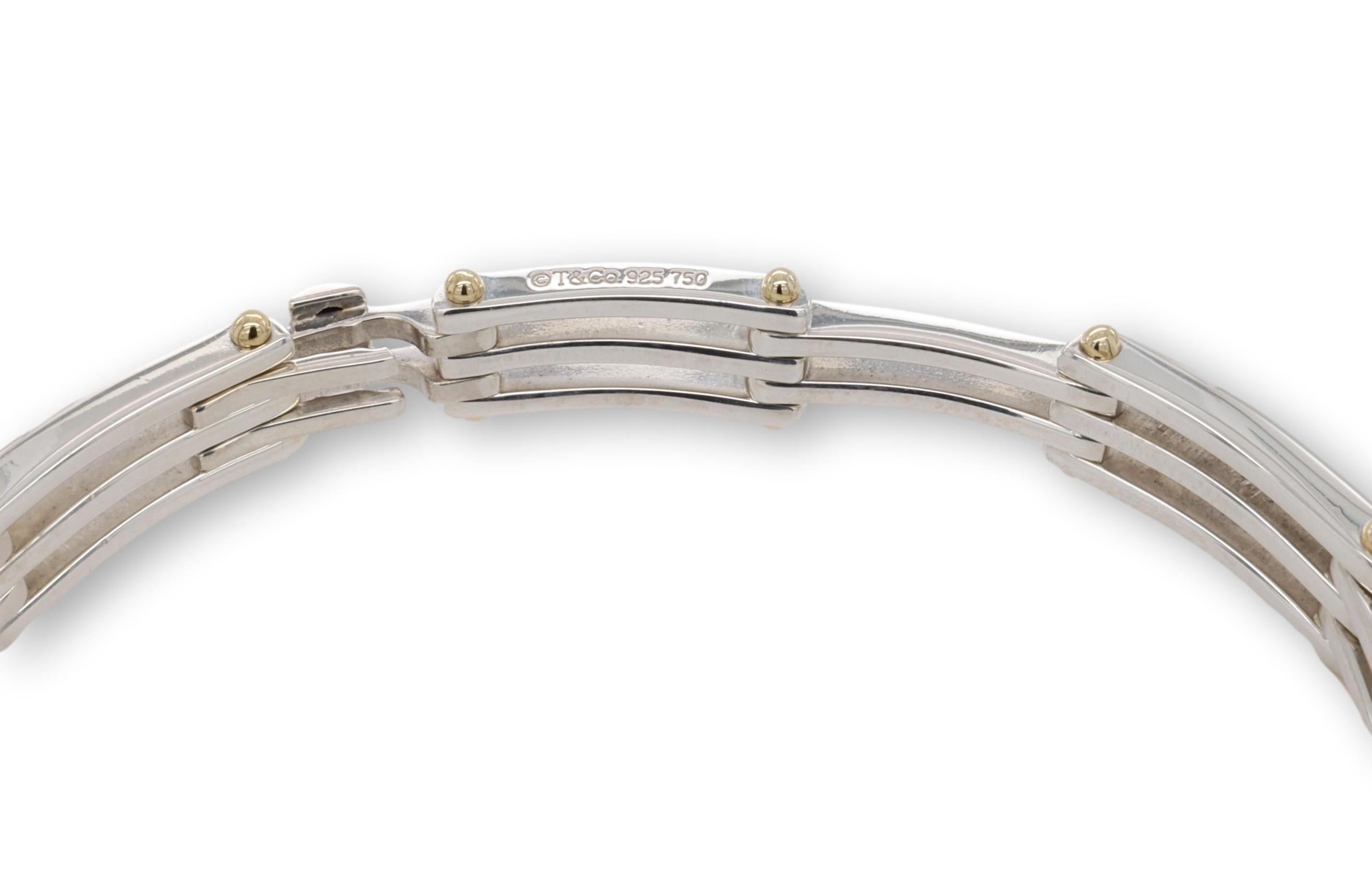 Vintage Tiffany & Co. men's bracelet in an open scroll Gate Link design finely crafted in sterling silver accented by 18K yellow gold beads throughout with a slide lock closure. Bracelet measures 11mm with beads and 8mm without. Fully hallmarked