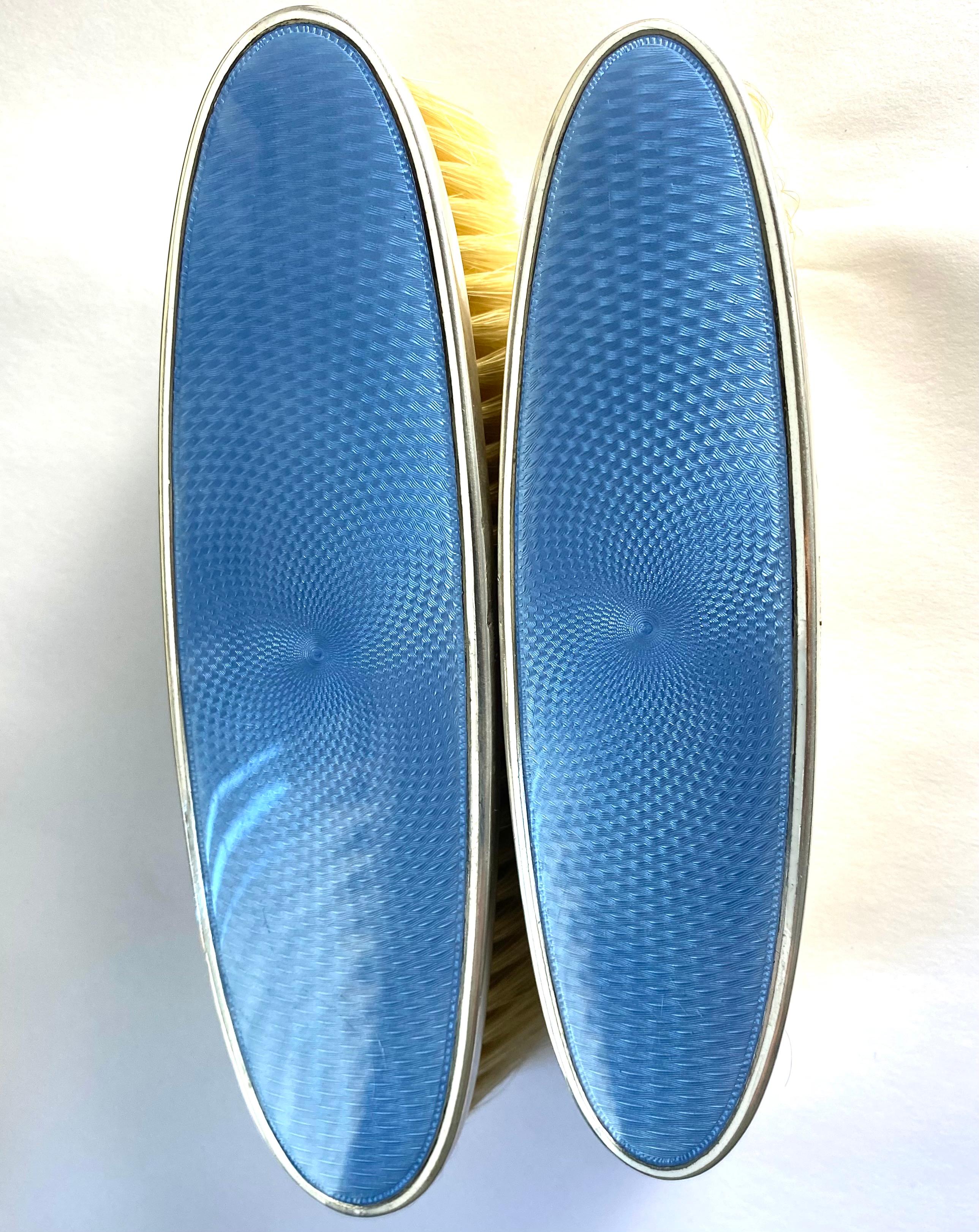 Add Timeless Elegance to Your Collection
Elevate your collection with this stunning pair of vintage clothes brushes from the esteemed house of Tiffany & Co. Meticulously crafted from sterling silver and adorned with exquisite blue guilloché enamel,