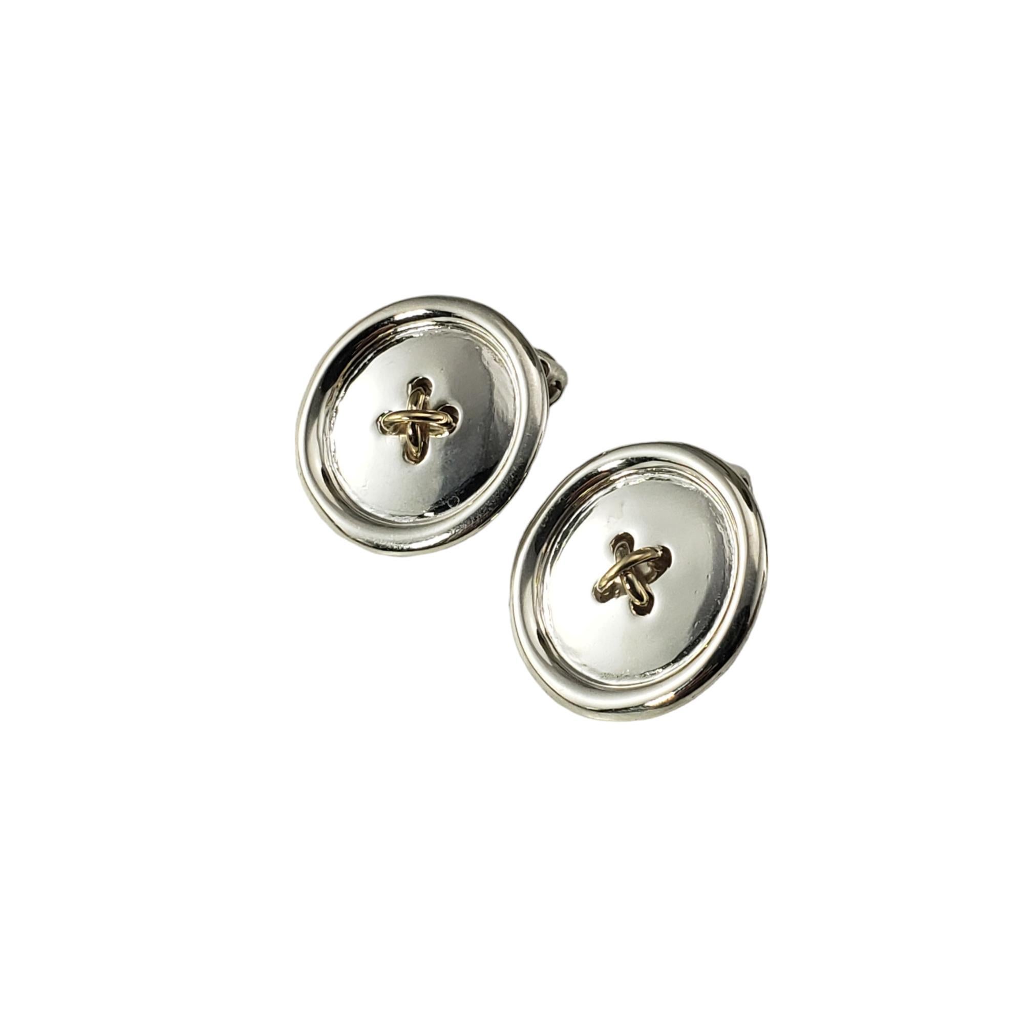Vintage Tiffany & Co. Sterling Silver and 14K Yellow Gold Button Clip On Earrings-

These button earrings by Tiffany & Co. are crafted in sterling silver and accented with 14K yellow gold.  Clip on closures.

Size: 18 mm

Hallmark:  TIFFANY & CO. 14