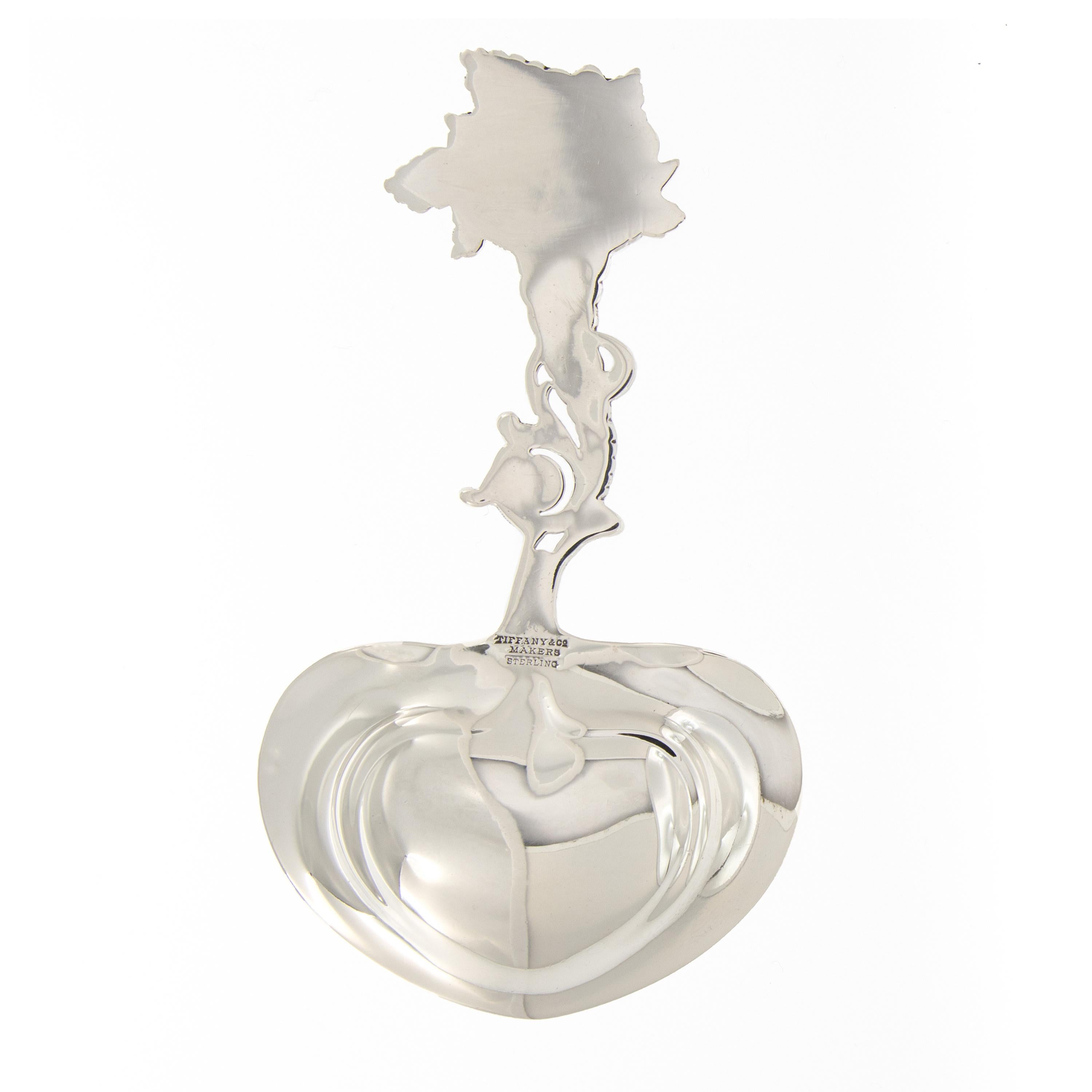 Awaiting your purchase is a rare and magnificent sterling silver Art Nouveau bonbon or tea caddy spoon with heart-shaped bowl made by the silversmiths Tiffany & Co. of New York, New York, in a delightful Cornucopia of Fruit pattern, under the