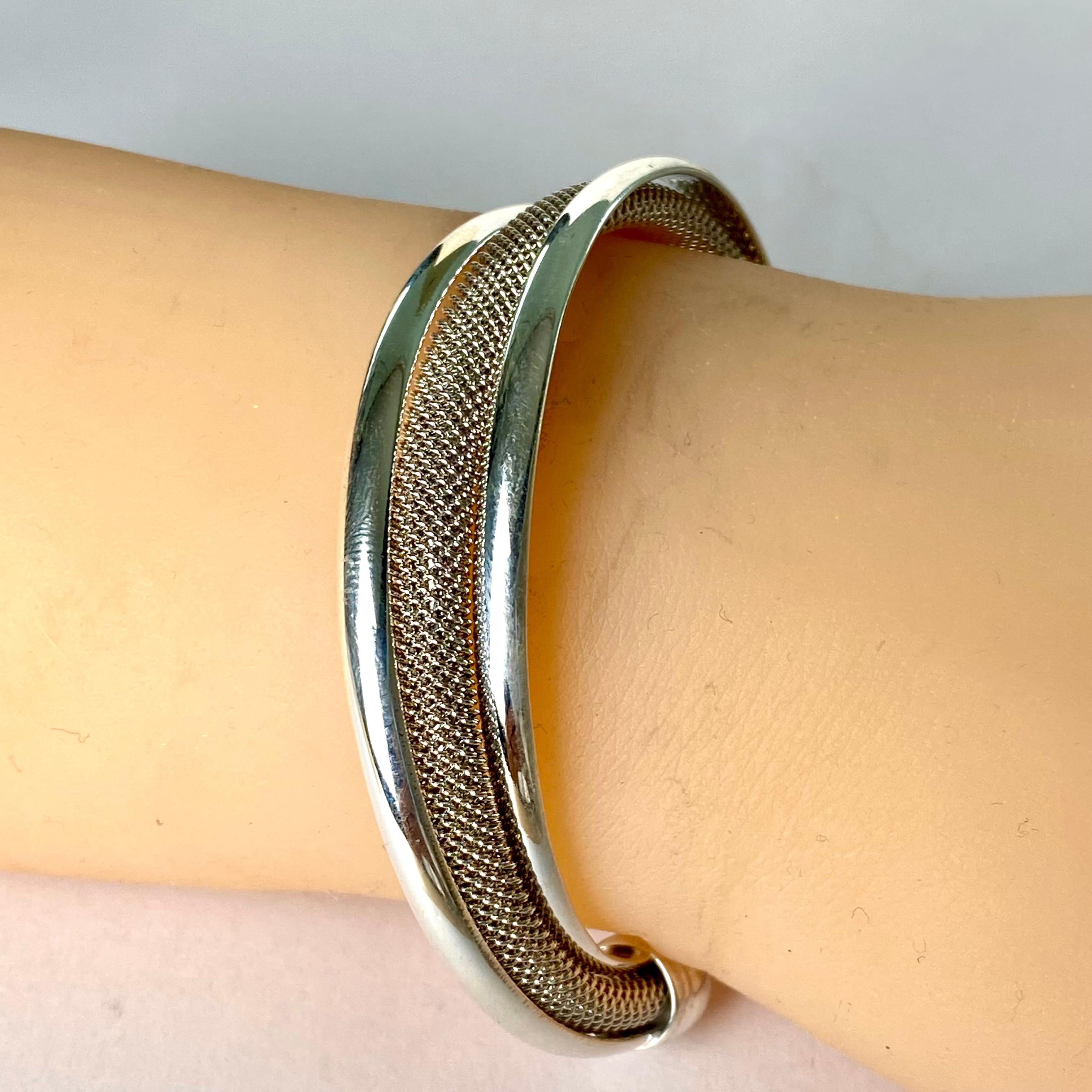 Introducing an exquisite piece of jewelry for discerning collectors and aficionados of timeless elegance – the Vintage Tiffany & Co Sterling Silver Cuff Bracelet. Crafted with precision and artistry by the renowned Tiffany & Co, this cuff bracelet
