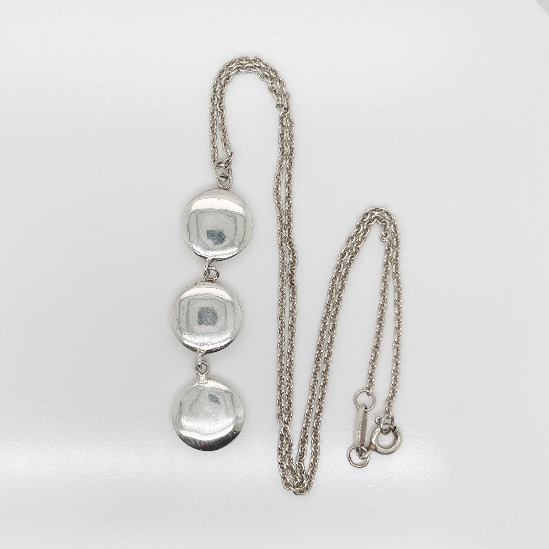 A very fine vintage Tiffany & Co. sterling silver disc or 'triple dot' pendant necklace.

Classically elegant design by Tiffany!

Date:
21st Century

Overall Condition:
It is in overall good, as-pictured, used estate condition with some very fine &