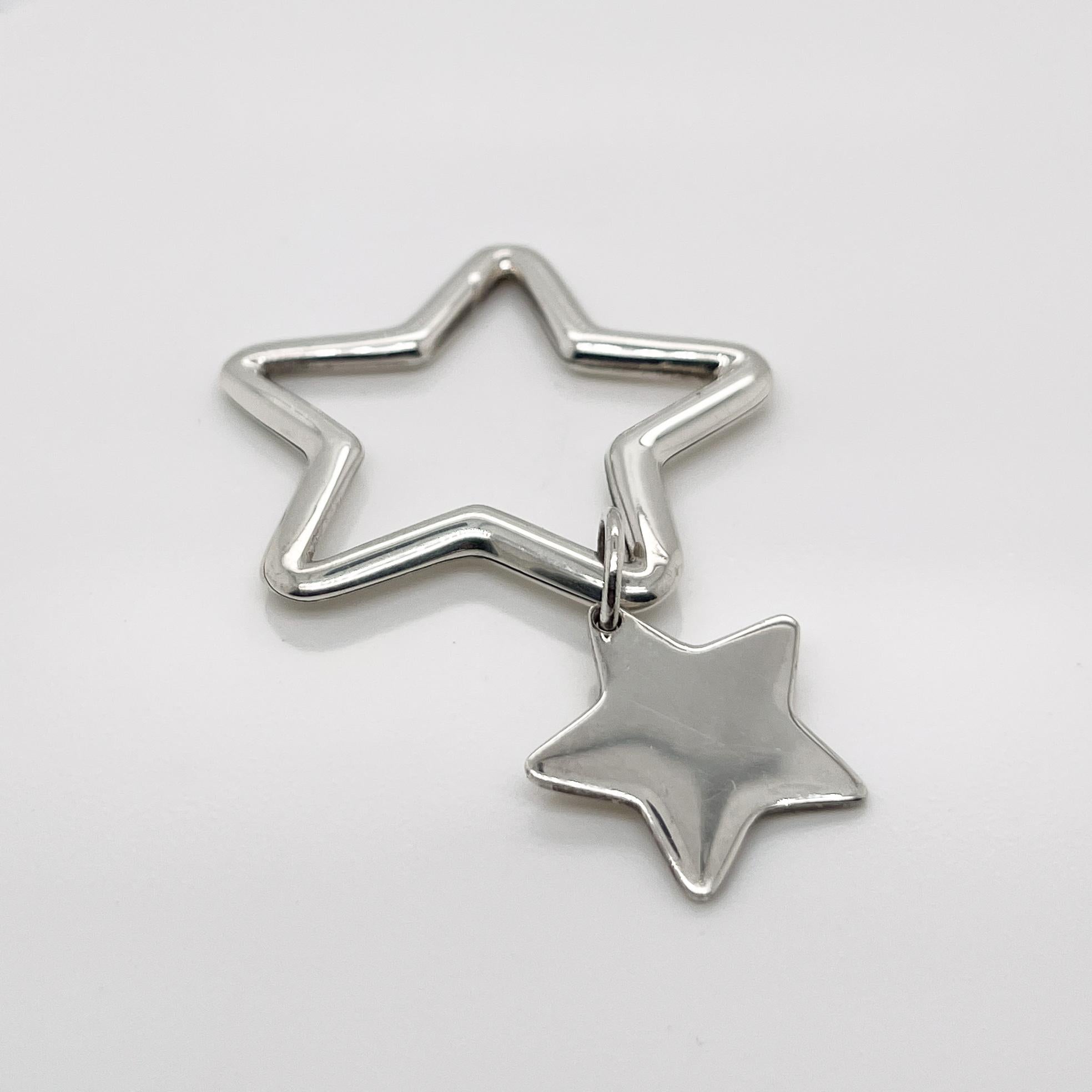 A fine Tiffany & Co. double star key holder.

In sterling silver with a star-shaped pendant charm attached to a star-shaped key holder.

Simply a great piece!

Date:
20th Century

Overall Condition:
It is in overall good, as-pictured, used estate