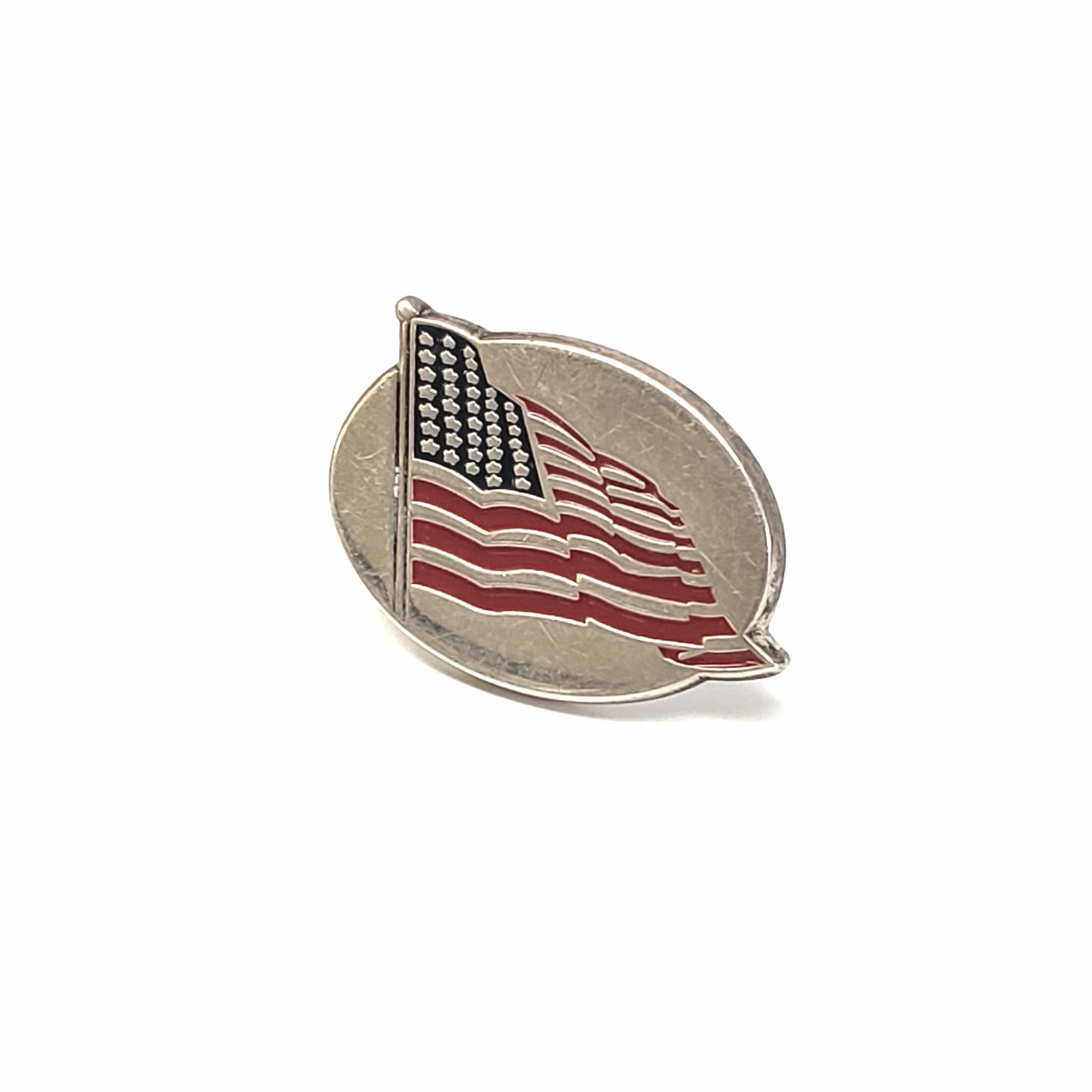 Vintage sterling silver and enameled American Flag lapel pin by Tiffany & Co, circa 2001.

This classic Tiffany design features an oval pin with a waving American Flag. No backing.

Measures 7/8