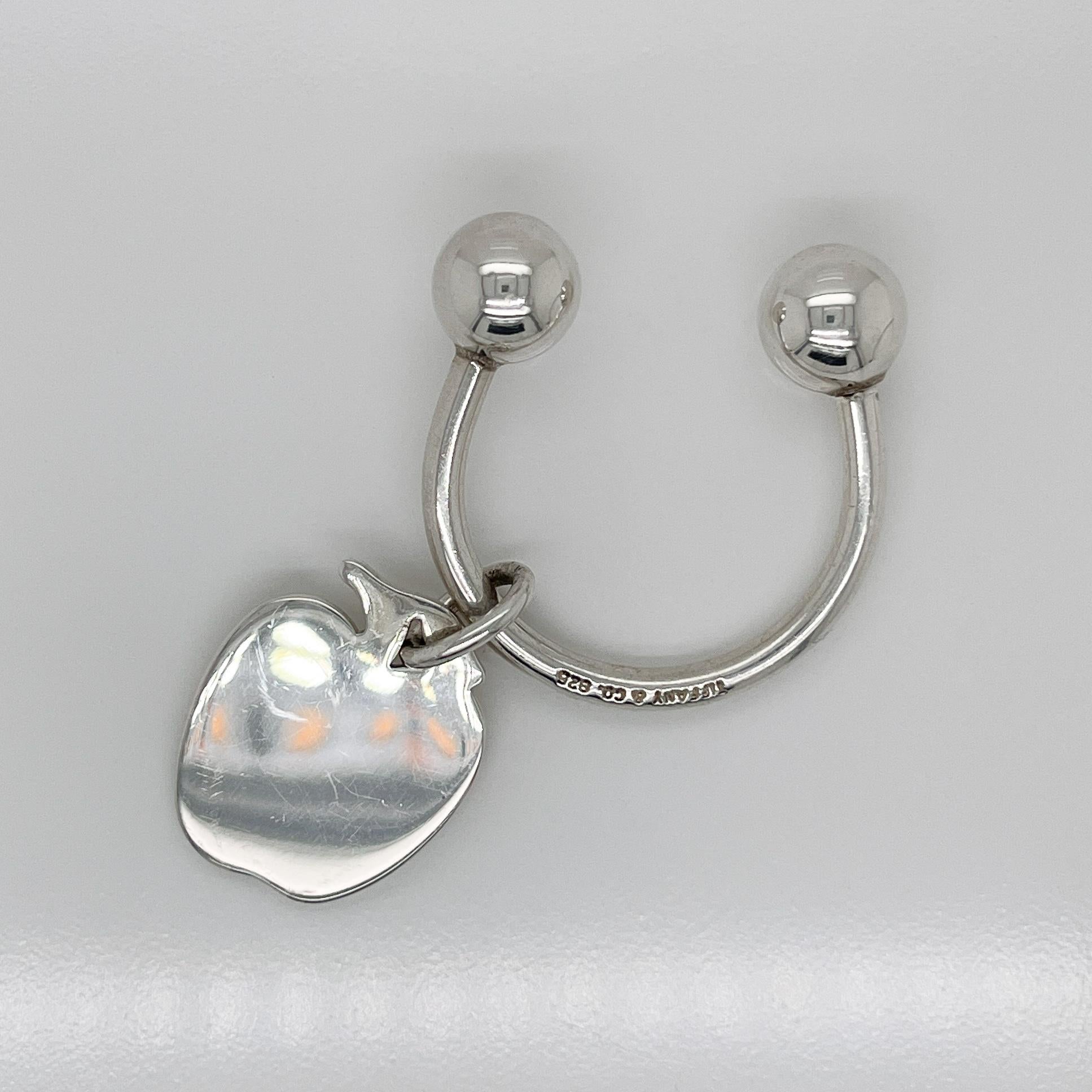 A very fine Tiffany and Co. key holder.

In sterling silver.

With an unengraved pendant tag in the shape of an apple.

A great everyday Tiffany piece!

Date:
20th Century

Overall Condition:
It is in overall good, as-pictured, used estate condition