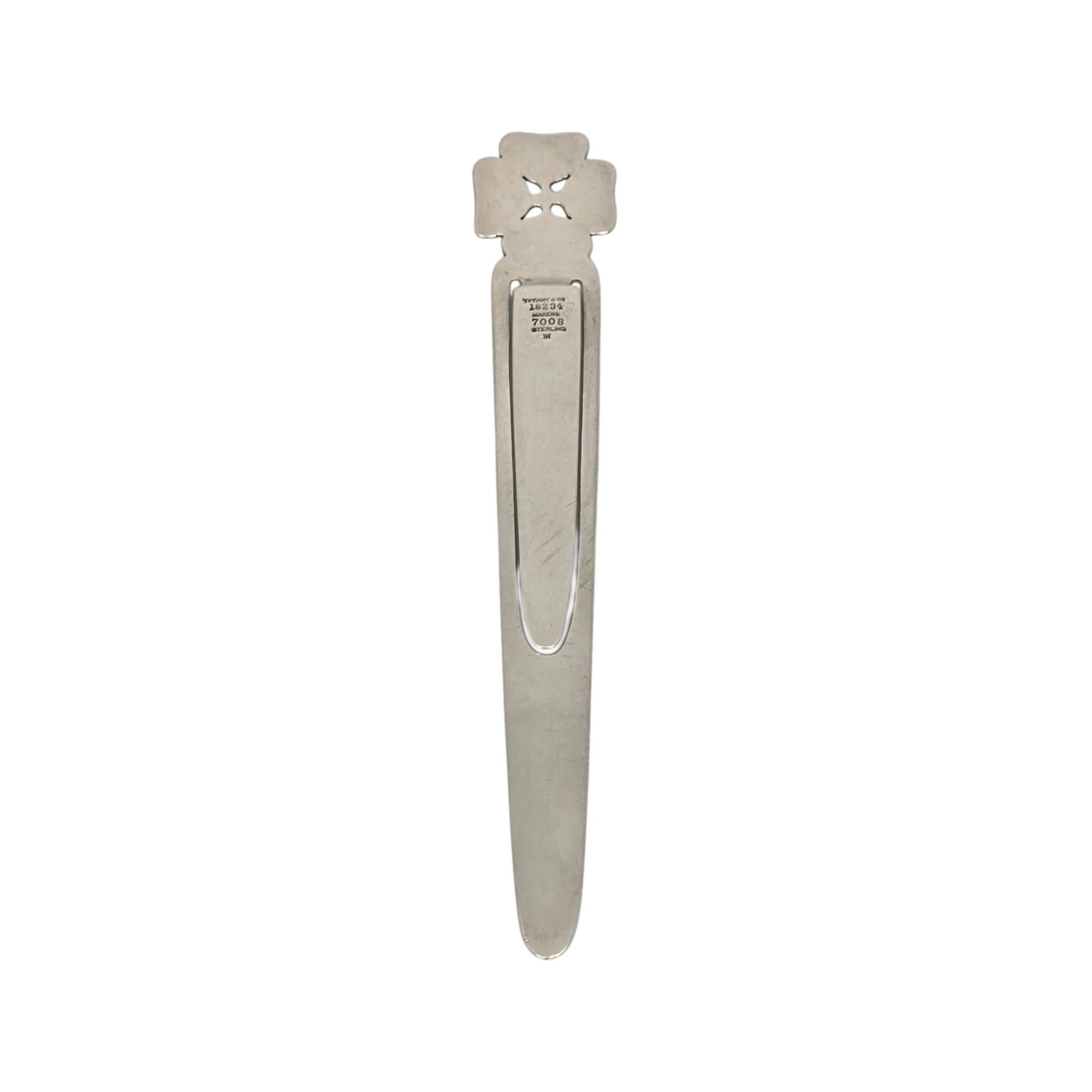 Sterling silver flower bookmark by Tiffany & Co.

No monogram or engraving.

A beautifully crafted bookmark featuring a sweet 4 petal flower design.  The M hallmark dates this piece to manufacture under the directorship of John C Moore, II, 1907-47.