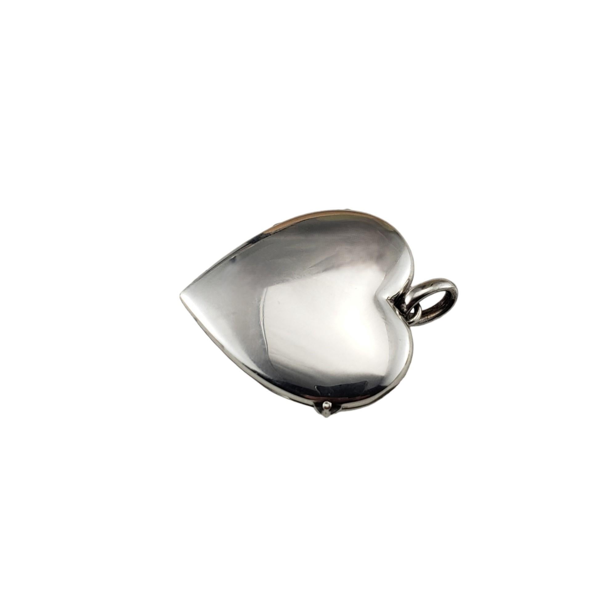 Vintage Tiffany & Co. Sterling Silver Heart Locket Pendant-

This stunning hinged heart locket by Tiffany & Co. is crafted in beautifully detailed sterling silver.  

Plastic for photo covers

Size: 37 mm x 35 mm

Hallmark: Tiffany & Co. Germany 