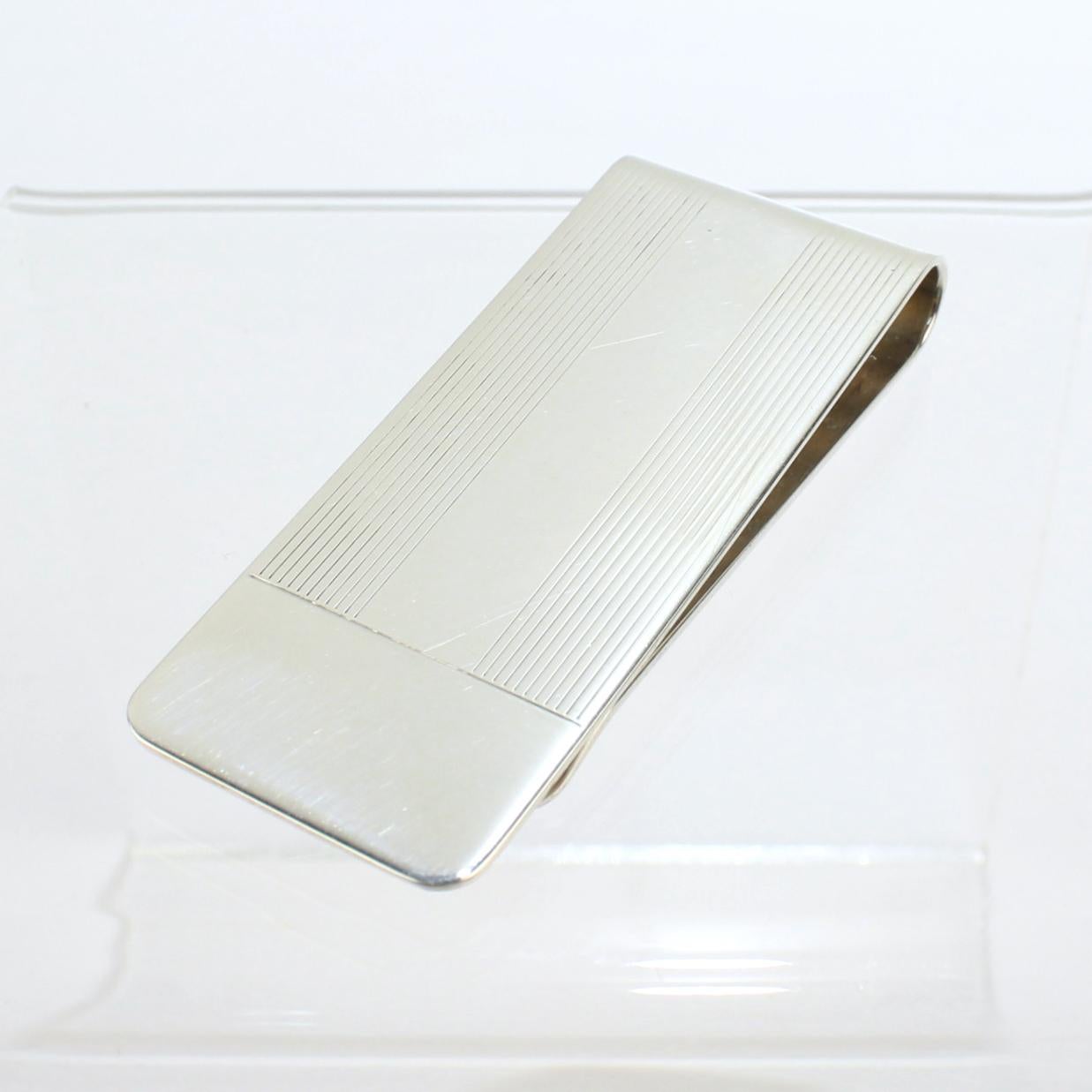 A very fine Tiffany & Co. money clip.

In sterling silver.

With linear engraved decoration.

A great Tiffany piece for everyday!

Date:
20th Century

Overall Condition:
It is in overall good, as-pictured, used estate condition with some very fine &
