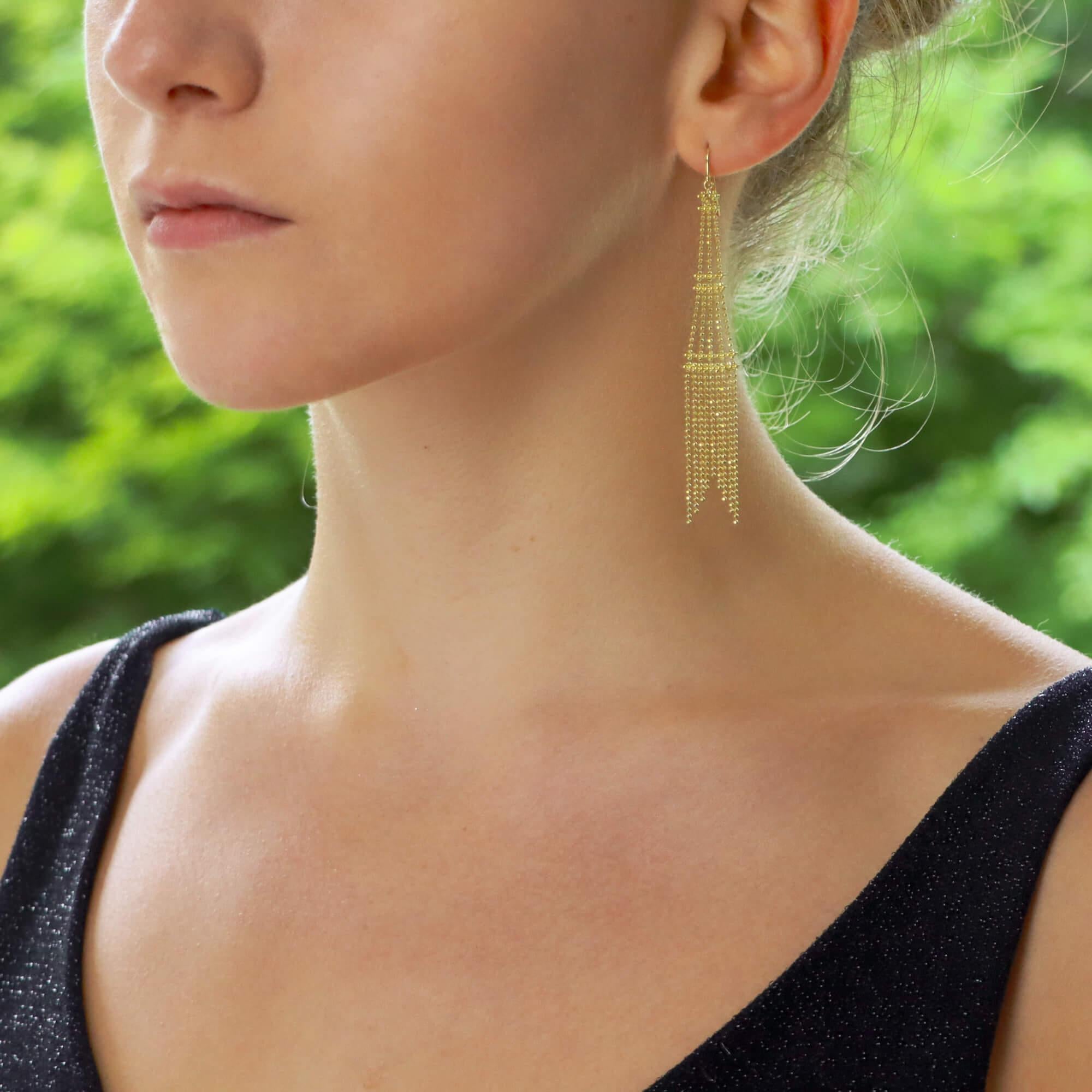A stylish pair of vintage Tiffany & Co. tassel chandelier drop earrings set in 18k yellow gold. 

Each earring is composed of a simple yellow gold balled chain which is designed in a tiered chandelier motif. They are secured with a Shepard’s hook