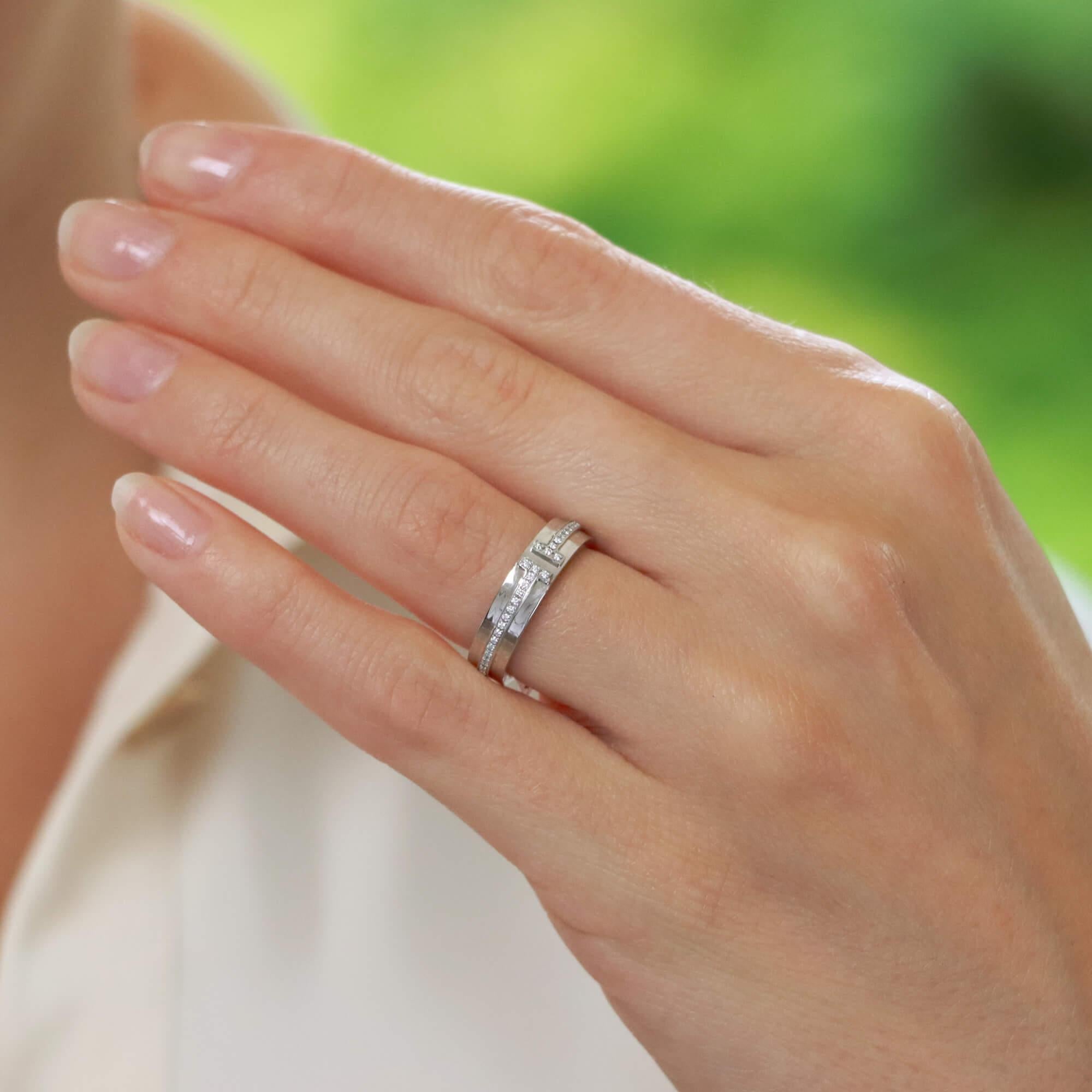  A stylish vintage Tiffany & Co. 'Tiffany T' narrow band diamond ring set in 18k white gold.

From the current Tiffany T collection, the ring is set with exactly 62 round brilliant cut diamonds in a polished white gold band design. The diamonds