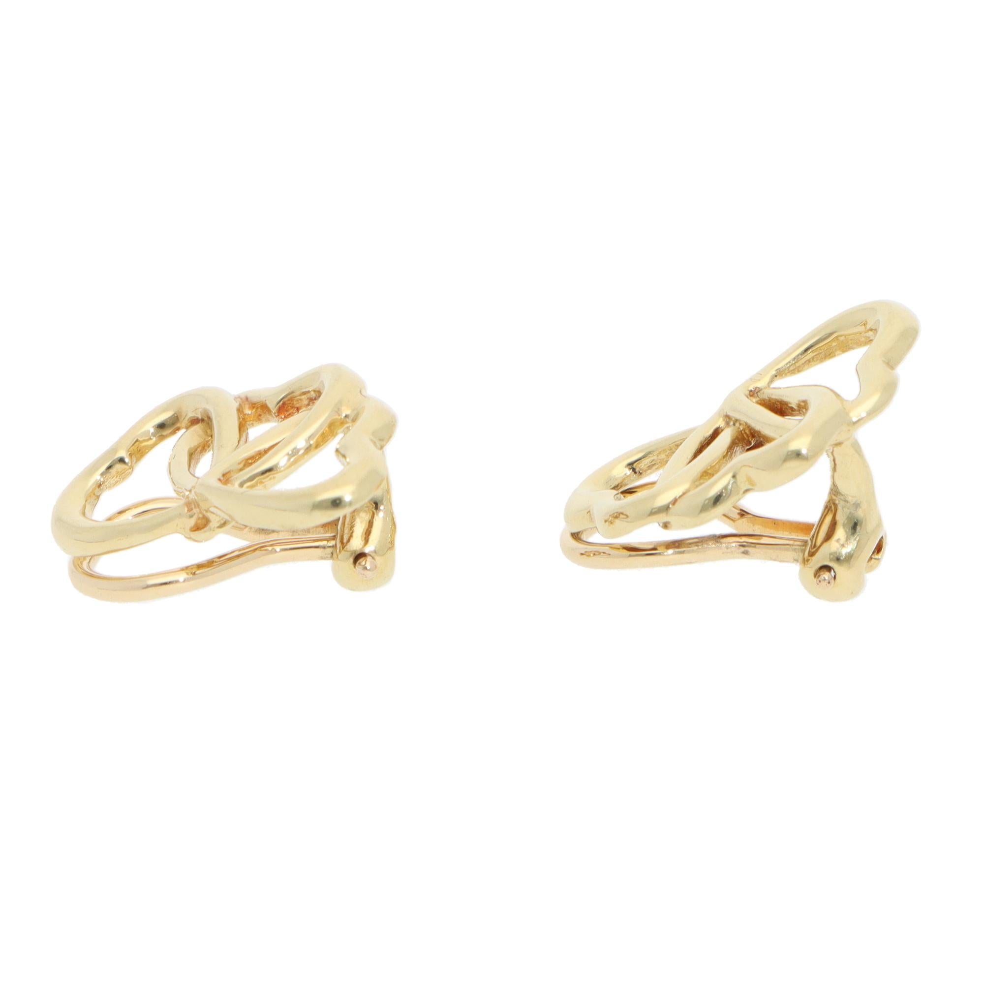 A lovely vintage pair of Elsa Peretti for Tiffany & Co. Open Heart clip earrings set in 18k yellow gold.

From the Elsa Peretti Open Heart collection, each earring is composed of three iconic open heart motifs. The hearts are set in polished yellow