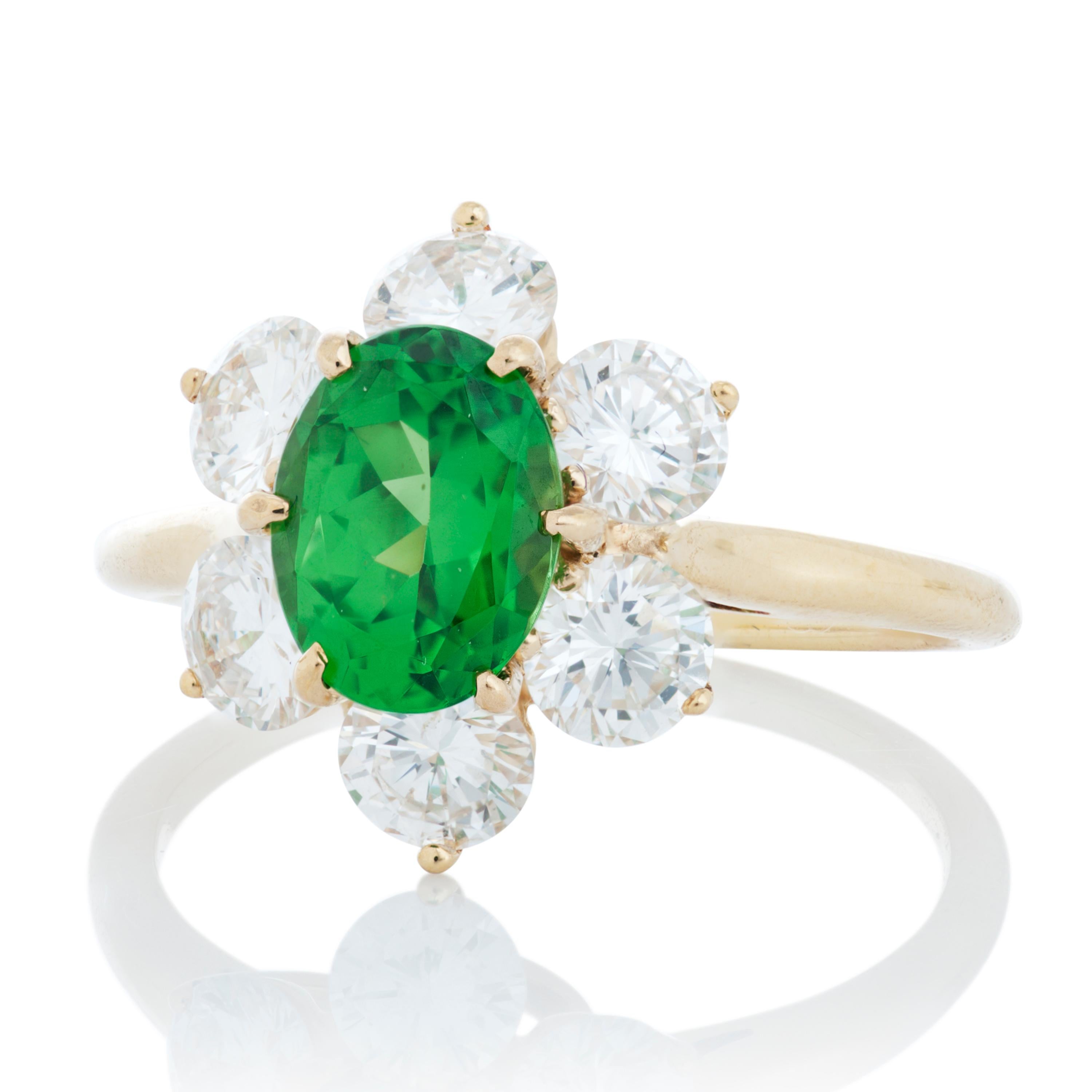 Vintage Tiffany & Co. tsavorite garnet and diamond Princess Diana style ring in 18k yellow gold, accompanied by Tiffany box.

The centerpiece of this Tiffany ring is a gorgeous green 1.65 carat oval tsavorite garnet in a six-prong setting,