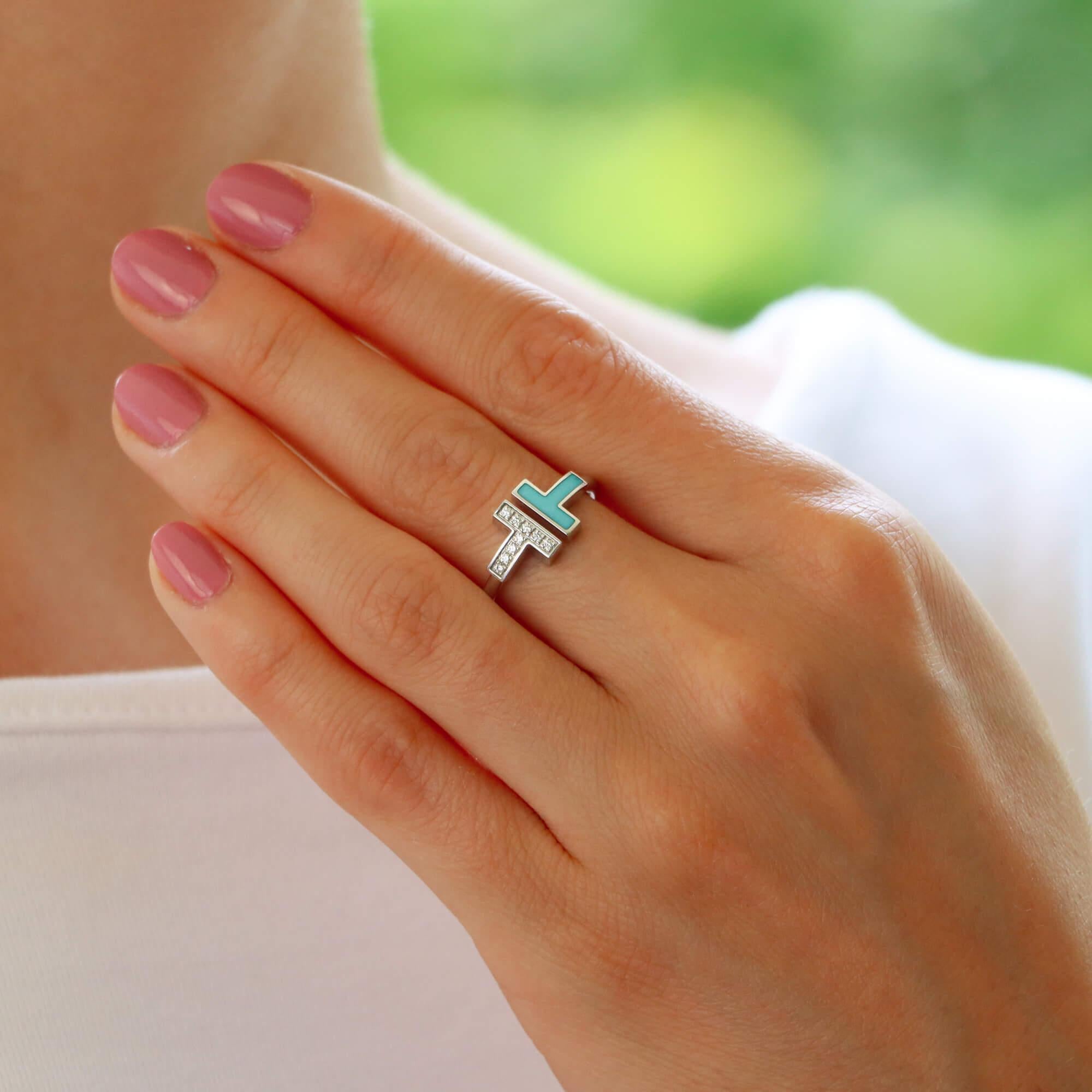 A stylish vintage Tiffany & Co. ‘Tiffany T’ turquoise and diamond ring set in 18k white gold.

From the current Tiffany T collection, the ring is set with exactly 9 round brilliant cut diamonds in a polished white gold band design. To the opposite