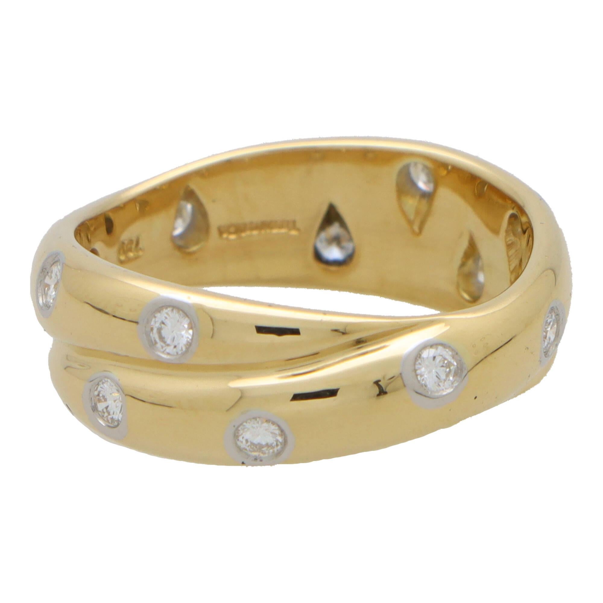 A lovely vintage Tiffany & Co. ‘Twisted Dots’ scattered diamond full eternity band ring set in 18k yellow gold and platinum.

The piece is composed of two soldered 4.5-millimetre solid gold bands, which are connected together to form a twisted