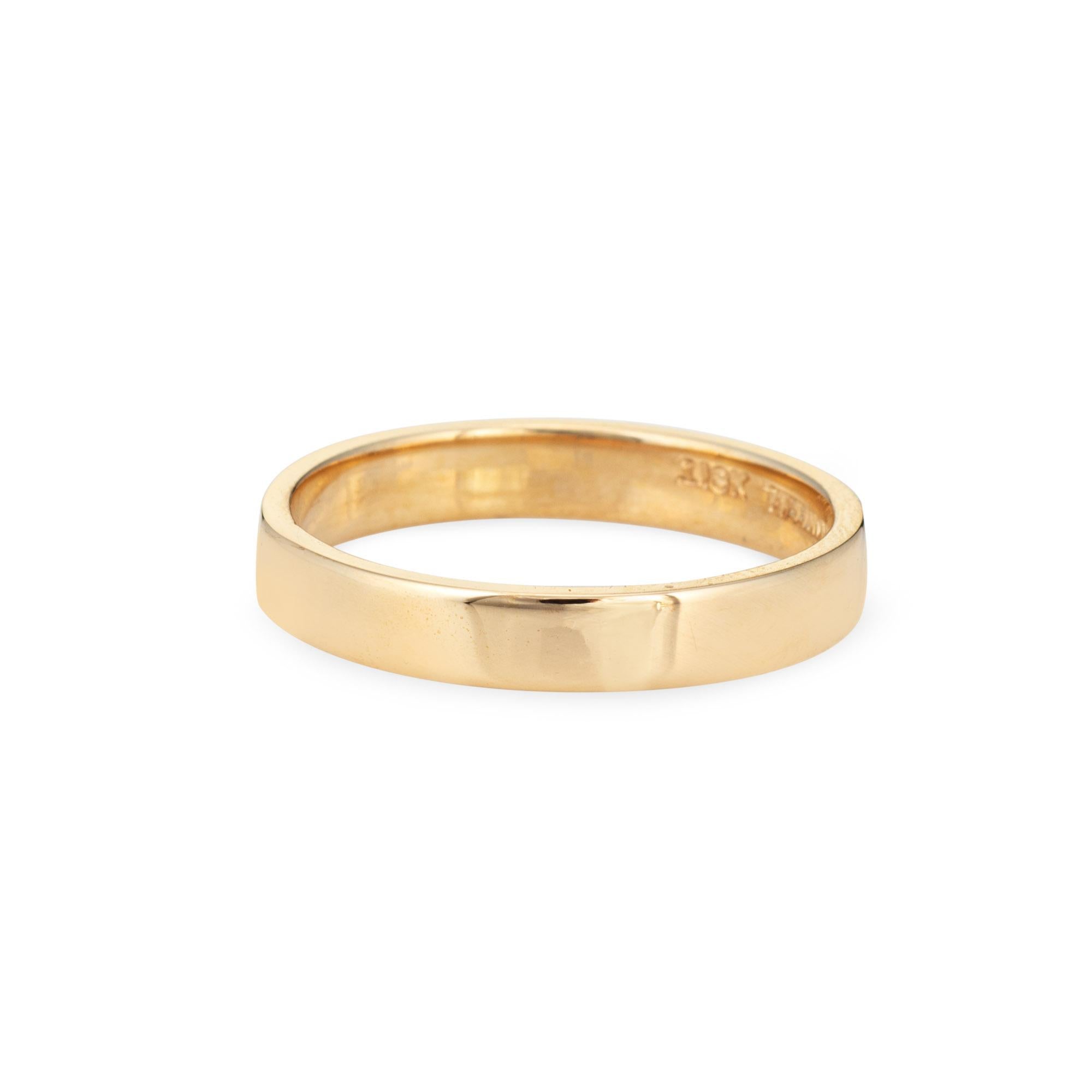 Vintage Tiffany & Co wedding band crafted in 18 karat yellow gold (circa 1950s to 1960s).  

The simple and elegant band has a flat design and high polished finished, measuring 4mm wide. It is ideal worn alone or stacked. 

The ring is in very good