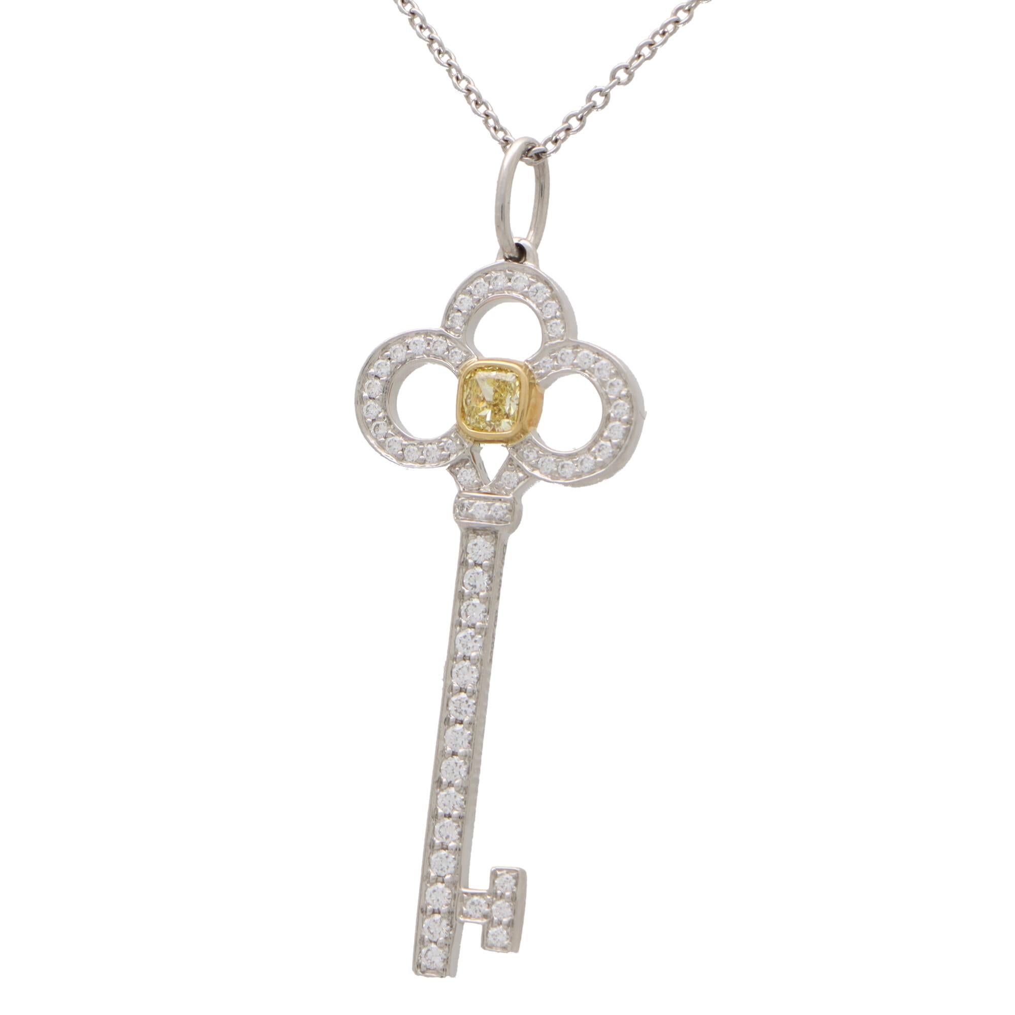 A beautiful vintage Tiffany & Co. yellow and white diamond key pendant set in platinum and 18k yellow gold. 

The pendant depicts an elegant key motif; rub over set centrally with a beautiful 0.18ct cushion cut yellow diamond. Within the stylized