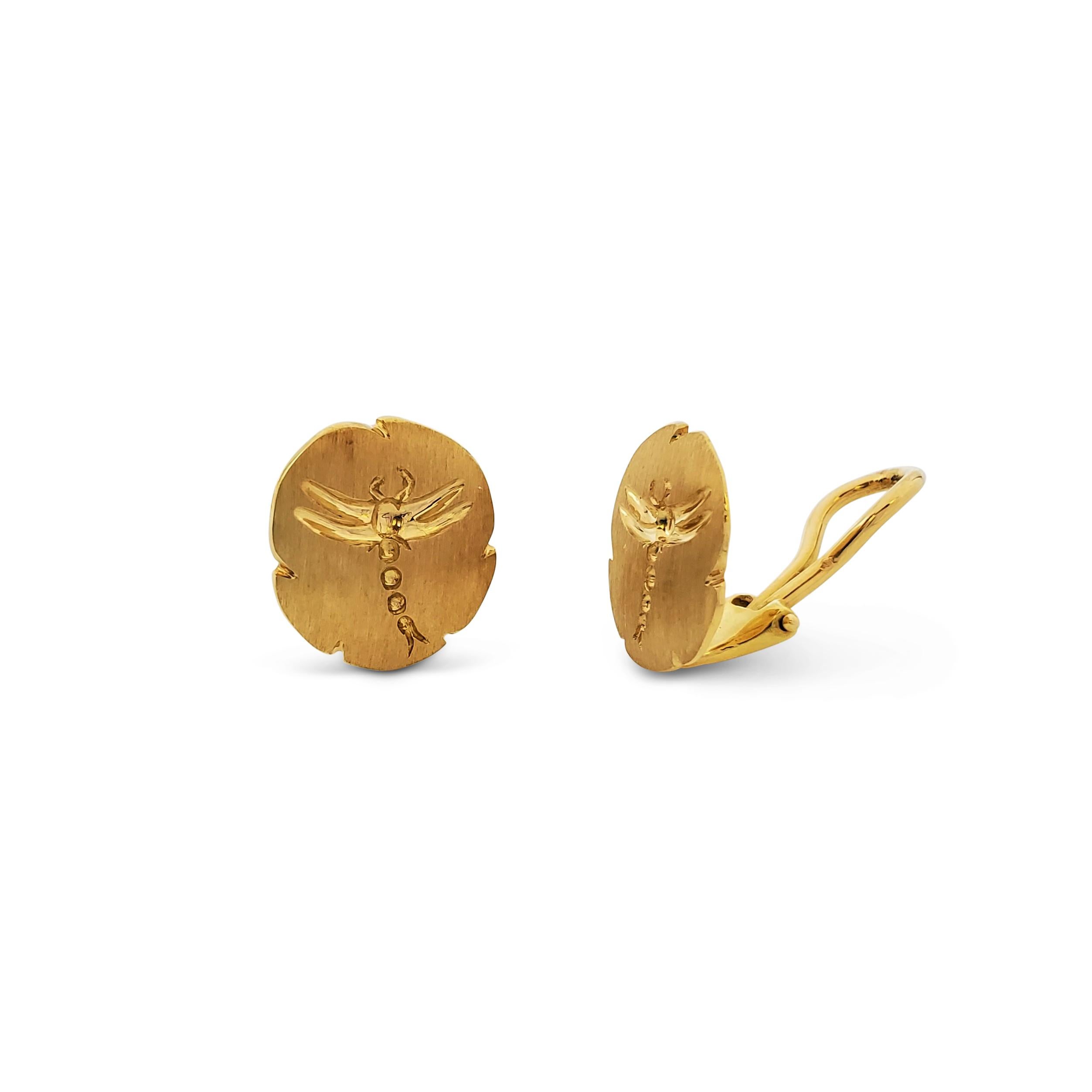 Authentic vintage Tiffany & Co. earrings crafted in 18 karat brushed satin-finished gold features an intricately carved dragonfly set in a solid gold lily pad. Signed T&Co., Italy, 750. Clip earrings without posts. The earrings are presented with