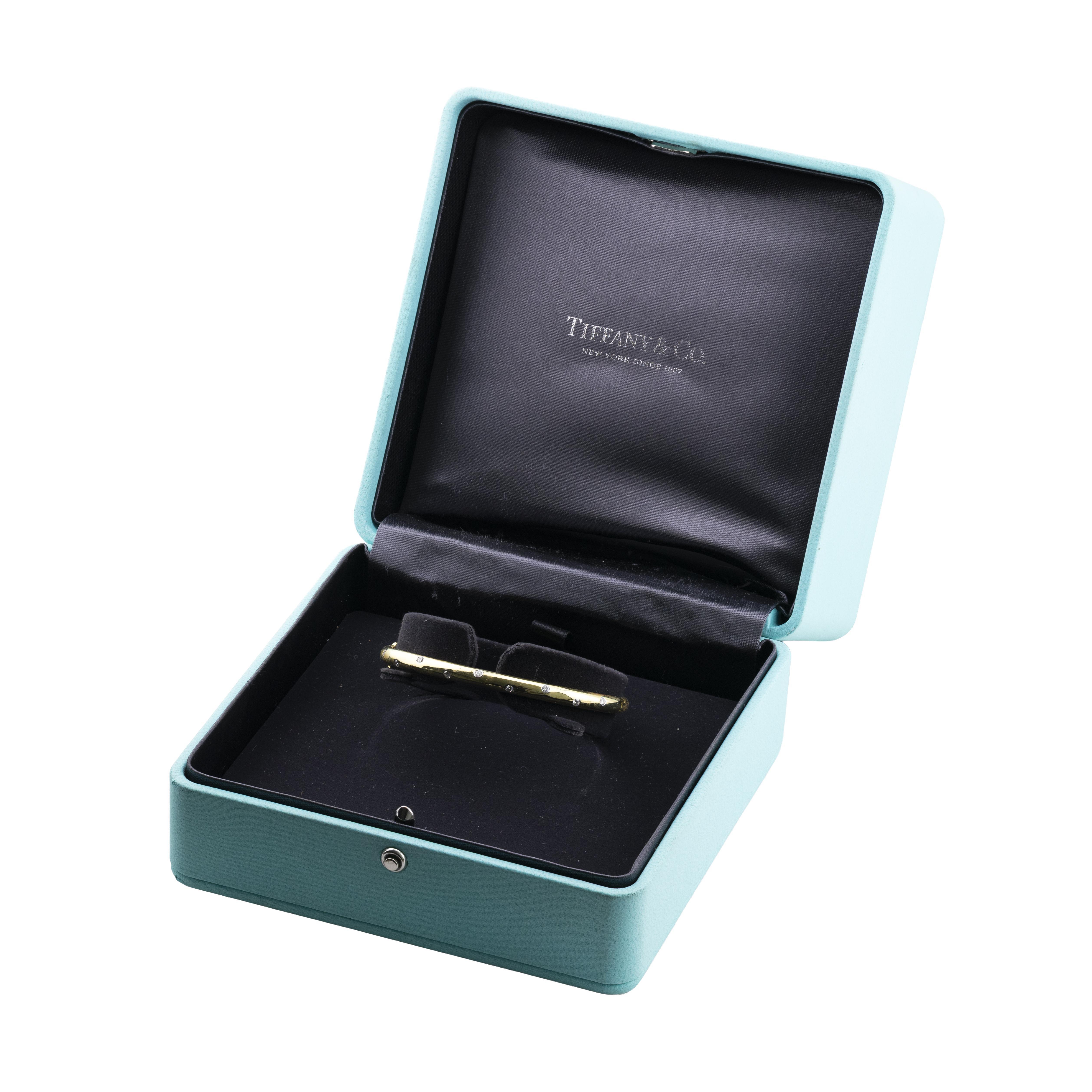 Aston Estate Jewelry Presents:

A vintage Tiffany 
Company Etoile collection bangle bracelet crafted in 18k gold and platinum. 

Adorned with brilliant-cut diamonds of 0.30CTW with a clarity of VVS2 and a color grade of F.

Hallmarked with