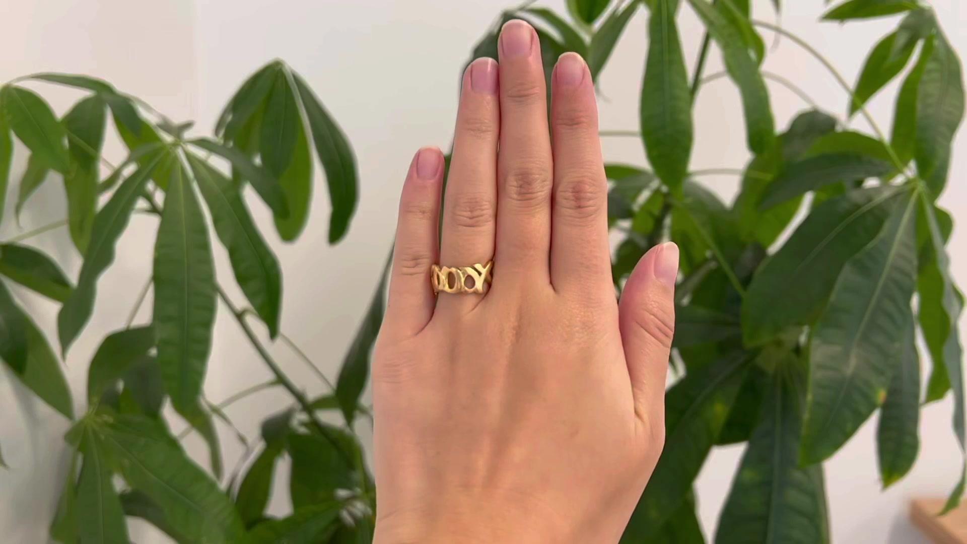 One Vintage Tiffany Paloma Picasso Graffiti XO 18 Karat Gold Band Ring. Crafted in 18 karat yellow gold, signed Paloma Picasso, T & Co., 1984. Circa 1984. The ring is a size 5 1/2. 

About this Item: Elevate your style the moment you wear this