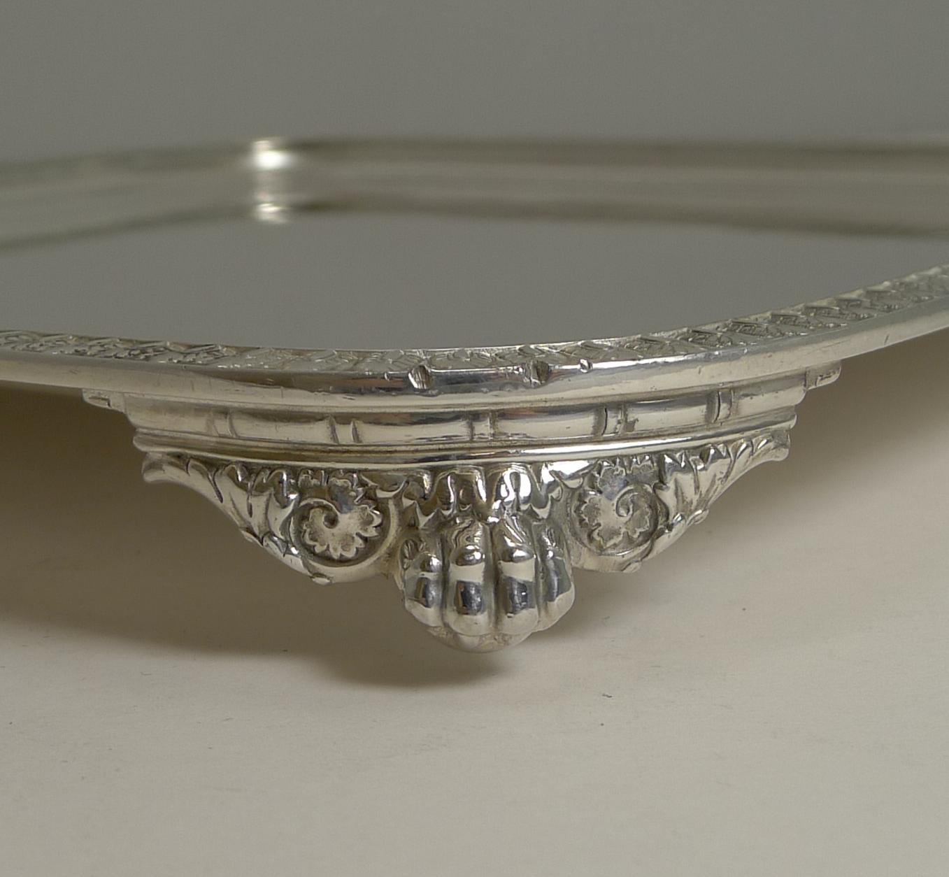 A very smart vintage silver plated square serving tray with a simple decorative raised border.

The tray stands on four decorative ball and claw feet.

Mid-20th century and in excellent condition. The underside is fully marked Tiffany & Co. /