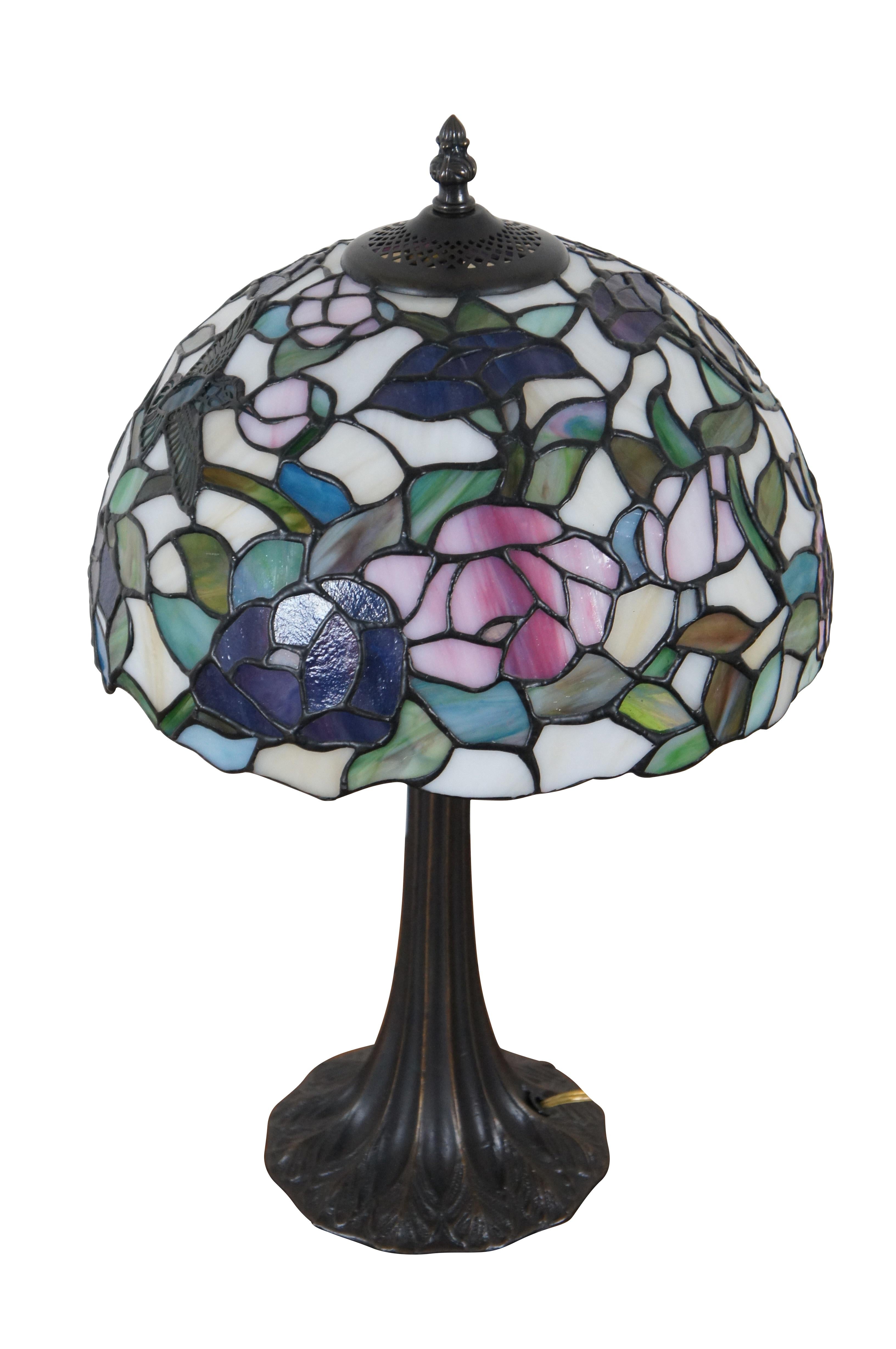 Vintage Tiffany style parlor table lamp.  Made of stained glass featuring Art Nouveau styling with a floral / rose and Hummingbird shade and leaf design tapered body.

Dimensions:
12.25” x 19.25” (Diameter x Height)