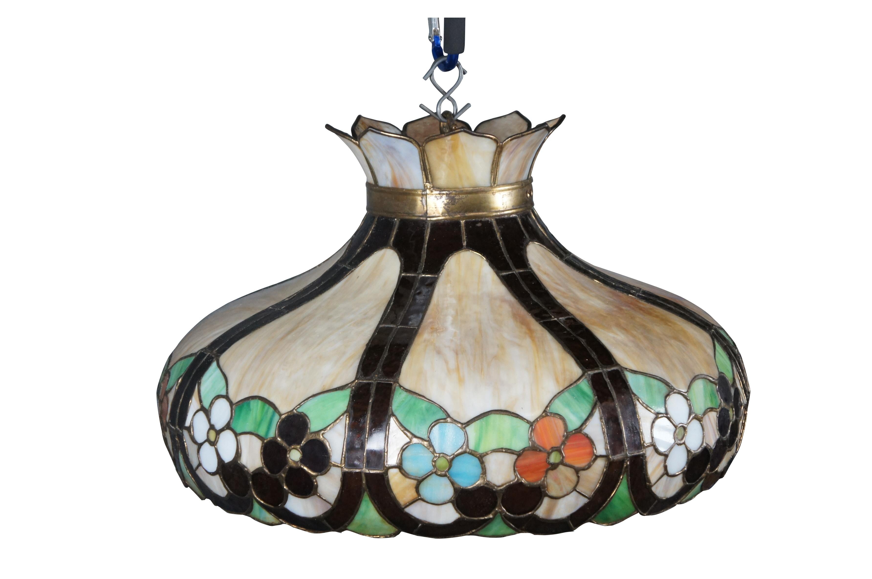 Mid to early 20th century Tiffany style slag glass / stained glass pendant light / shade / chandelier featuring a dome shape with scalloped lower edge, decorated with brown swirls cupping pairs of flowers and leaves, with petal shaped panels around