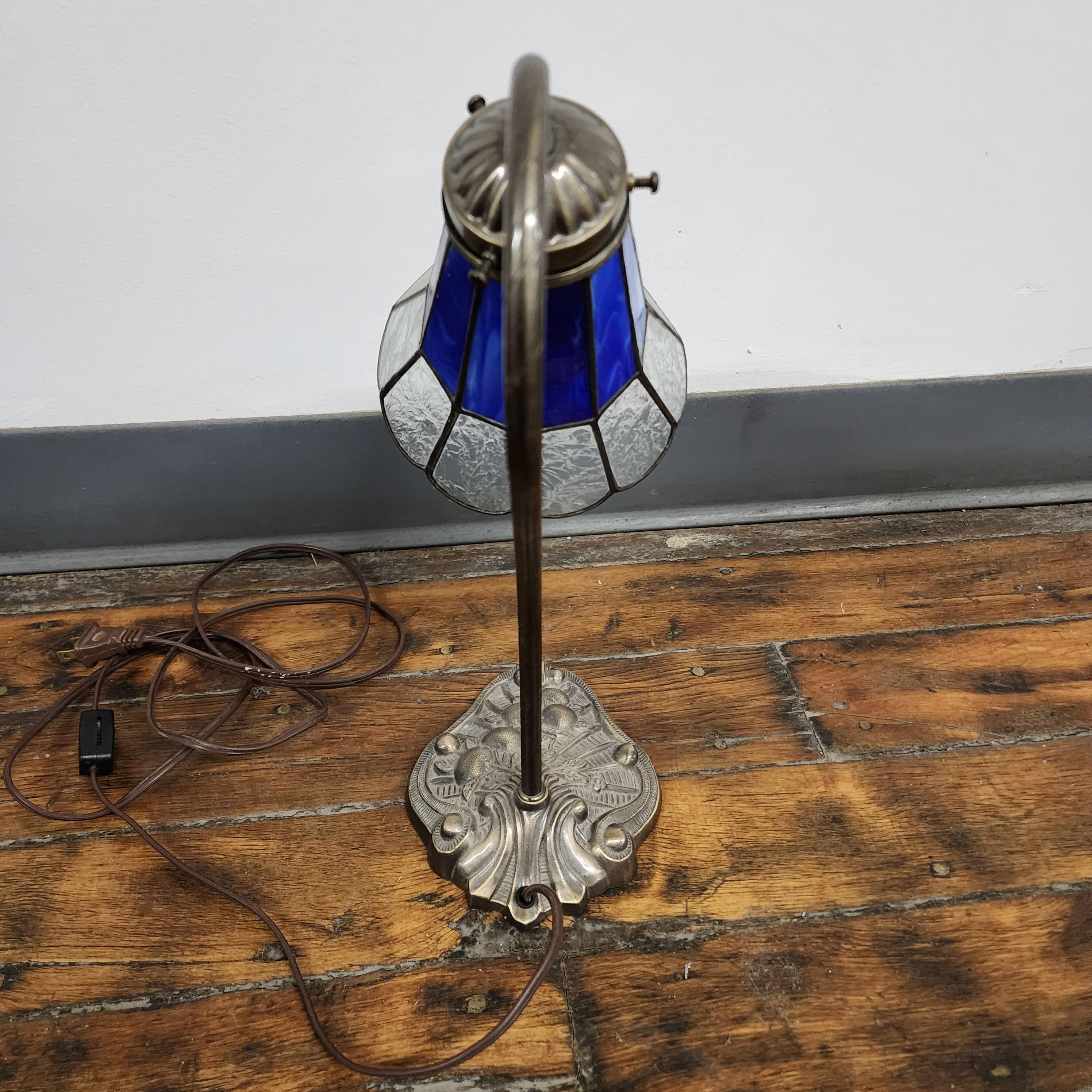 Vintage Tiffany style stained glass lily pad table lamp. Cast Lily pad decorative base with curved metal stem. Has beautiful blue and clear stained glass shade. Great shape, works perfectly.