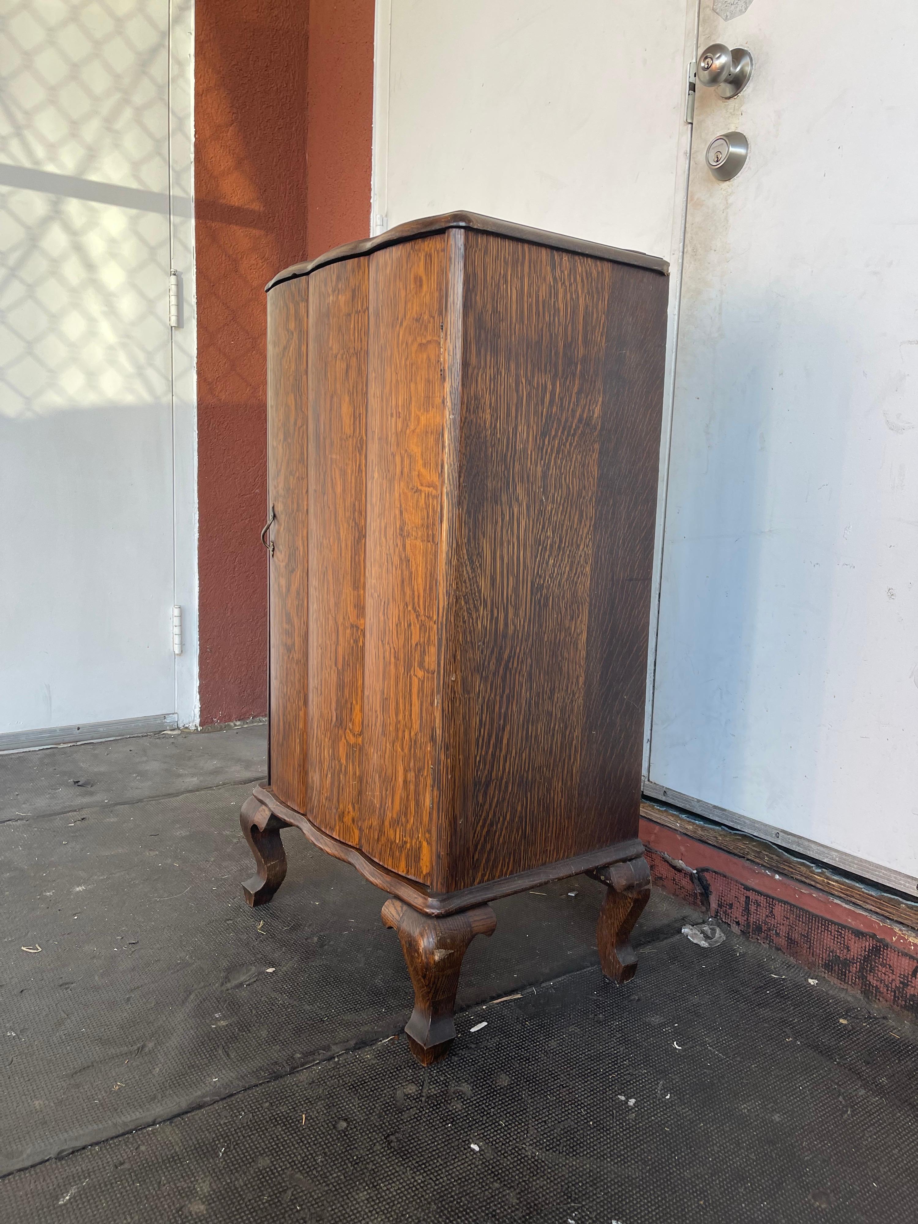 Vintage tiger oak sheet music cabinet with original finish and pad foot.