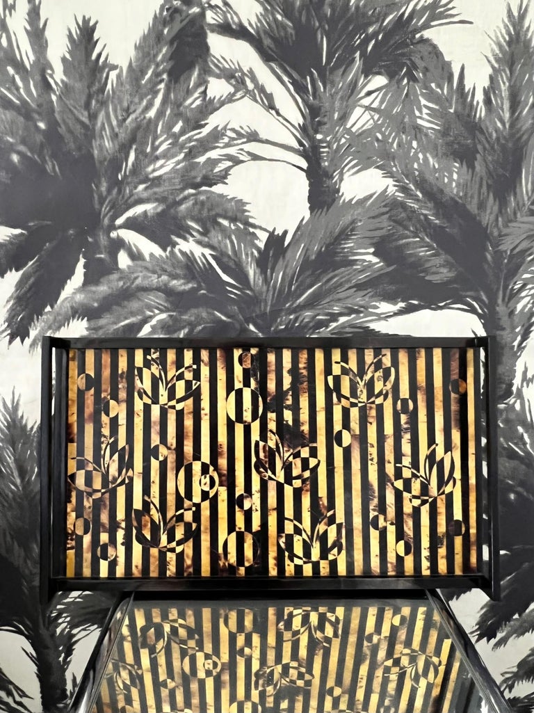 Organic modern tray in exotic tiger pen shell in striped hues of black, brown, and tan. The handcrafted tray features inlays of geometric circles and butterflies over a wood frame with sleek ebonized handles. This is a rare vintage find, as R&Y