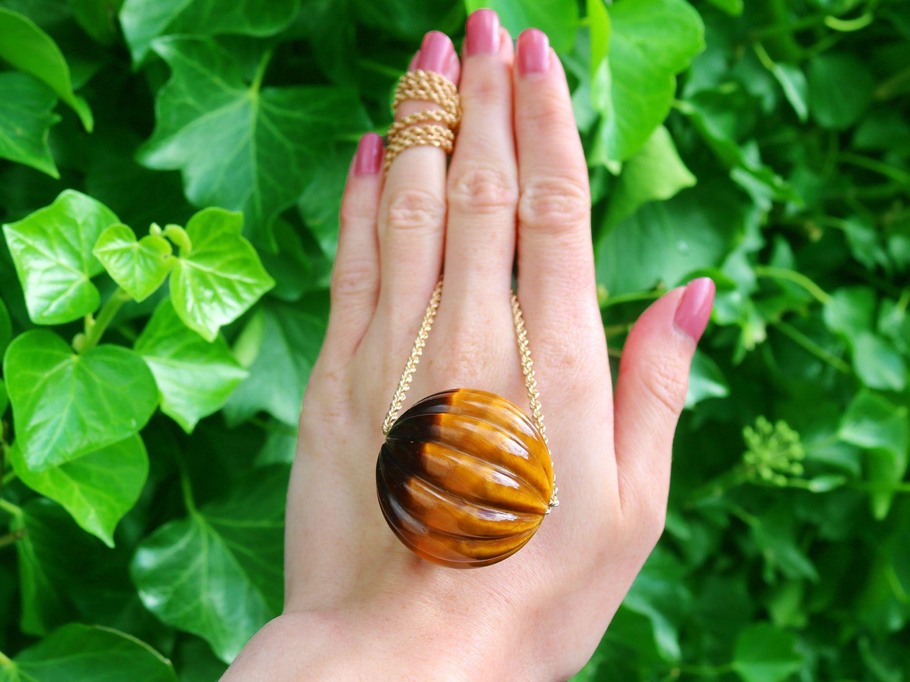 A stunning, fine and impressive vintage tigers eye and 14 karat yellow gold pendant; part of our diverse jewellery and estate jewelry collections.

This stunning, fine and impressive vintage pendant has been crafted in 14k yellow gold.

The