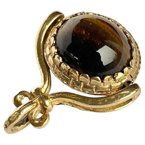 Tigerauge und drehbarer Vintage-Knopf aus 9 Karat Gold