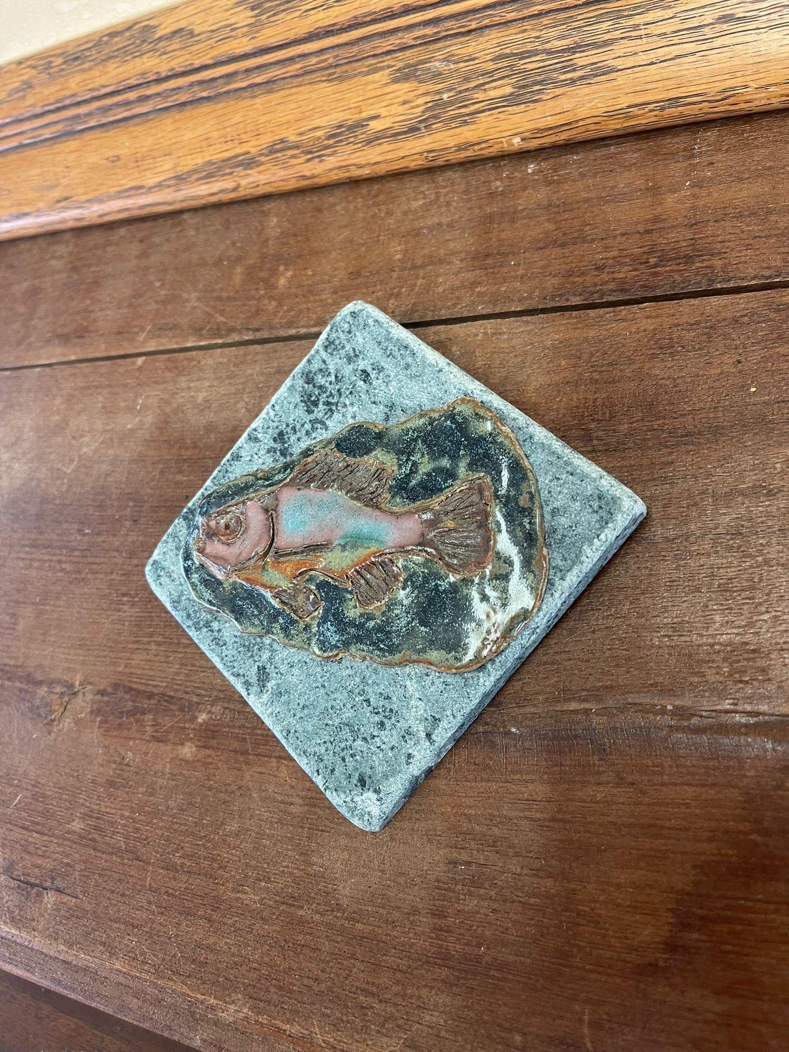 This Piece of Ceramic Artwork has been placed on top of a stone or marble base.Unable to verify if the base is stone or marble. Wall hanging hook on the back. No Makers mark. Vintage Condition Consistent with Age as Pictured.

Dimensions. 4 W ; 4 D
