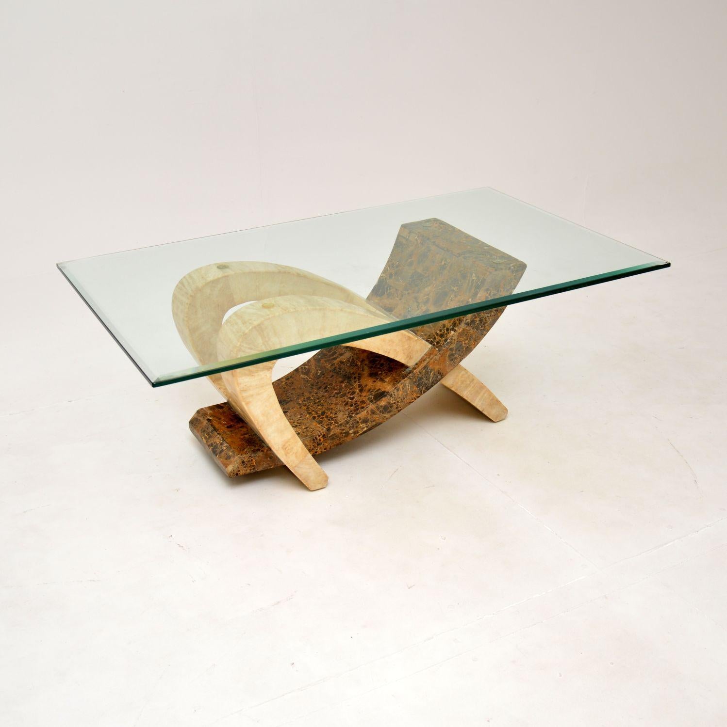 A very stylish and extremely well made vintage tiled marble coffee table with a glass top. This was made in Italy, it dates from around the 1970-80’s.

It is of superb quality, the base has a very interesting shape and is constructed from solid wood