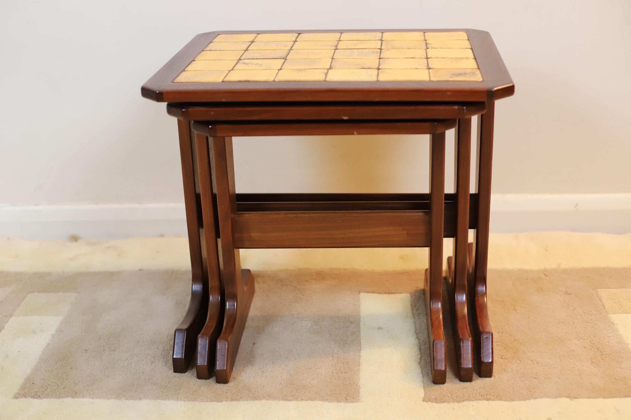 A Vintage tiled nest of 3 tables in teak, this nest of tables is one of the most efficient ways to save space in the home. Tucked away in a corner, they provide a quick and easy way to achieve more surface space in a room. This can be particularly