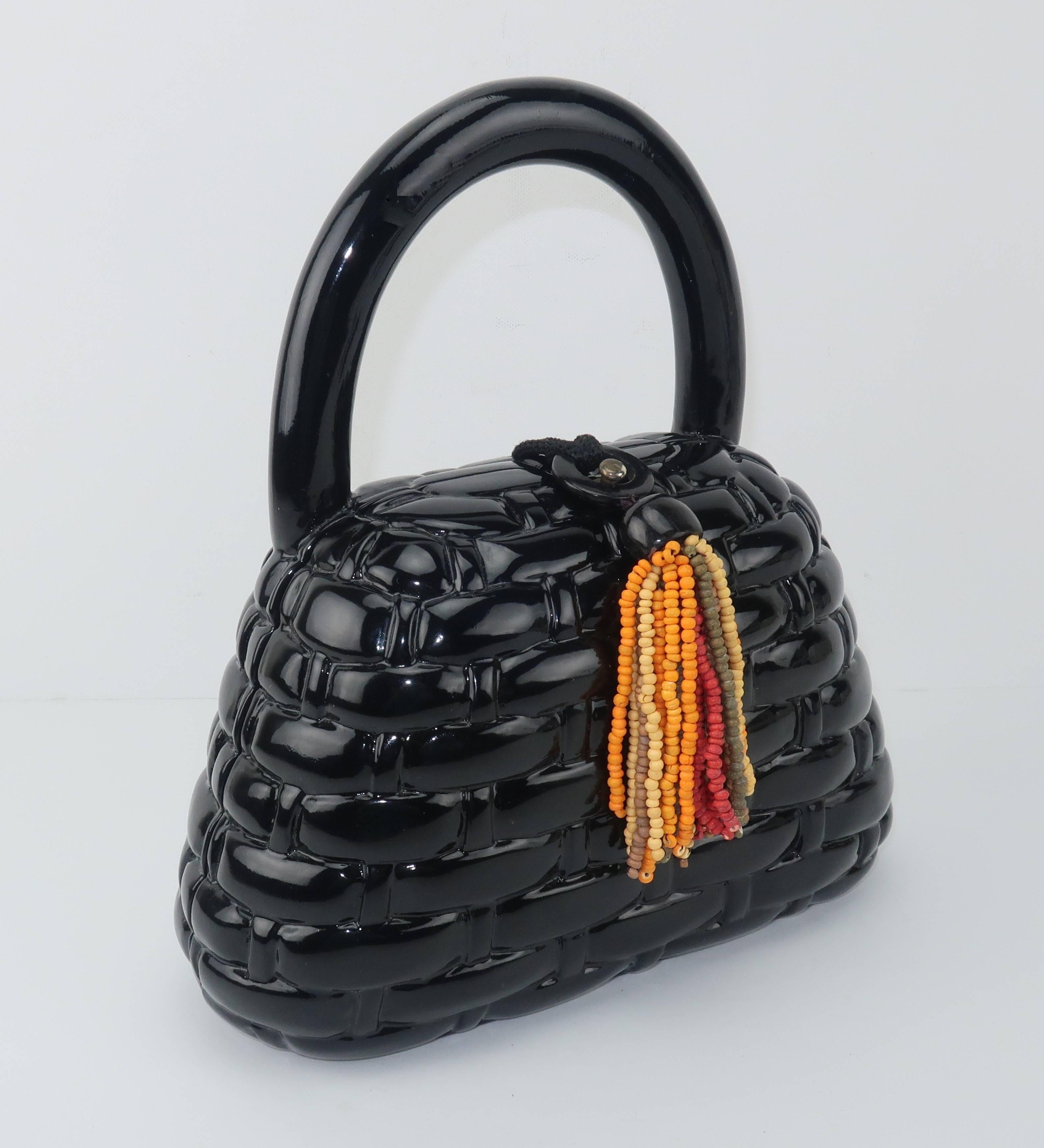 Witty ... whimsical ... wearable ... AND wooden!  This vintage Timmy Woods of Beverly Hills black lacquered wooden handbag is fabricated to look like a basket bag with the appearance of a lattice woven surface.  The colorful beaded tassel closure
