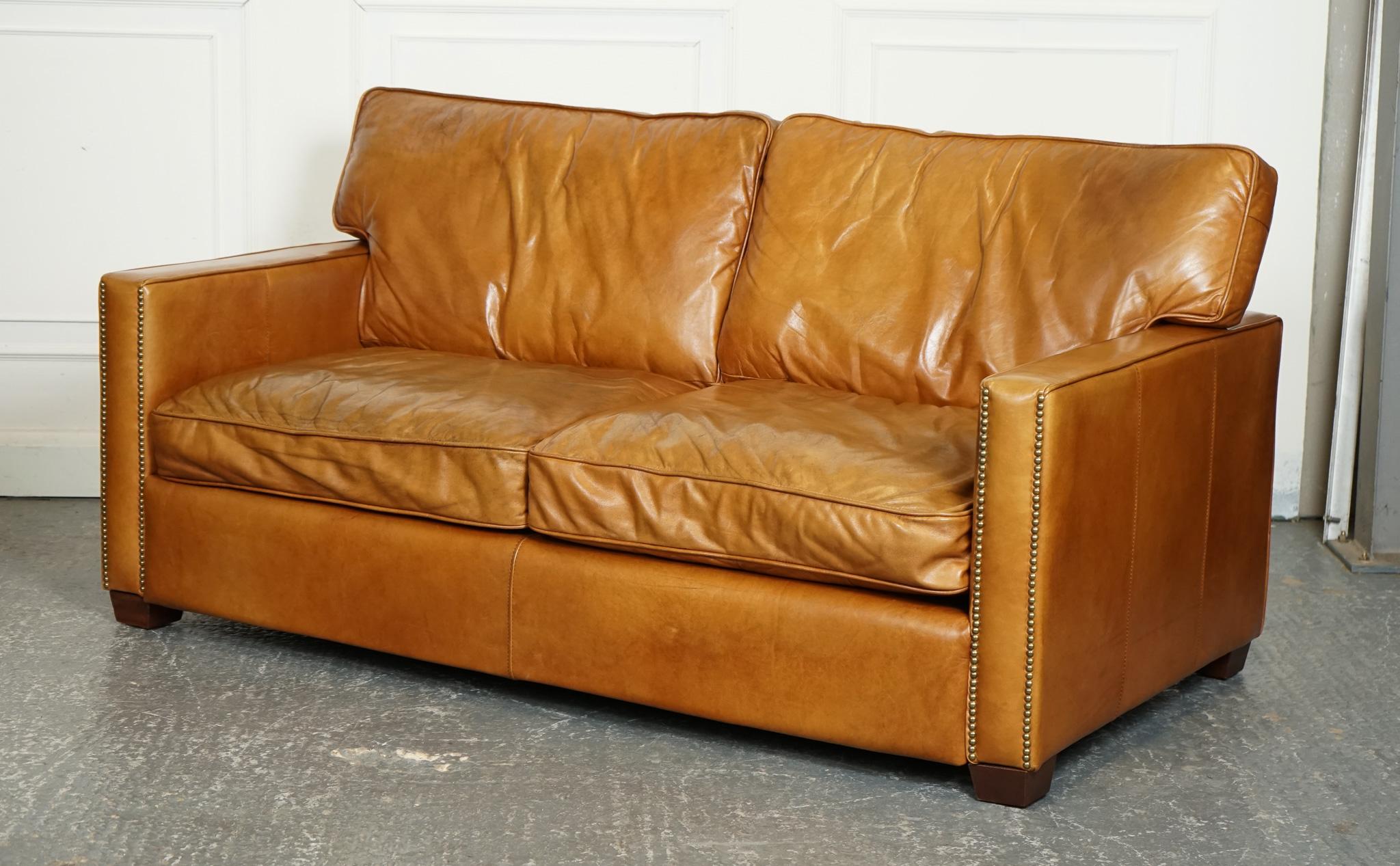 
We are delighted to offer for sale this Vintage Timothy Oulton Viscount Tan Leather 2 to 3 Seater Sofa.

 A stunning piece of furniture that exudes luxury and style. Crafted by the renowned designer Timothy Oulton, this sofa is the epitome of