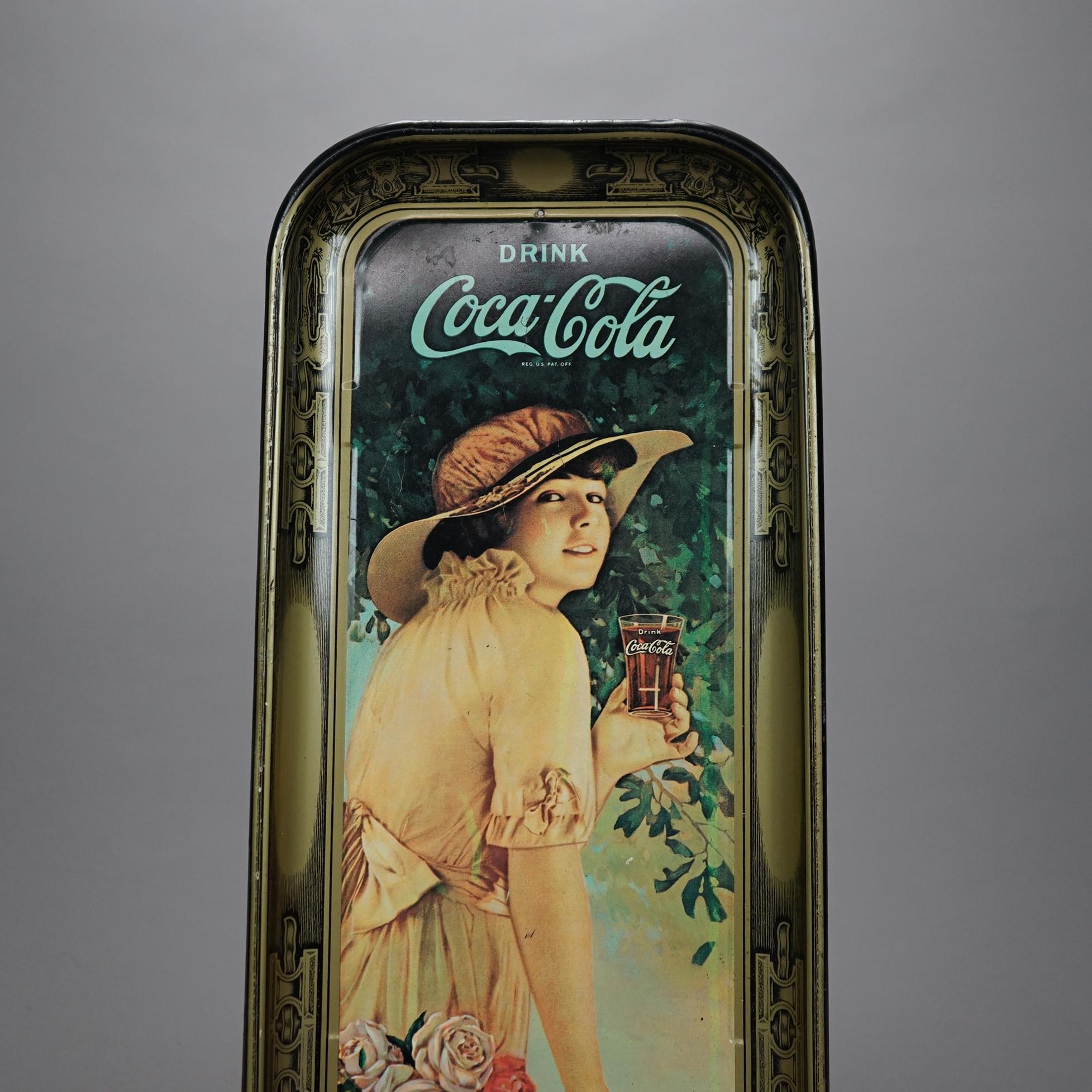An vintage metal Coca-Cola advertising tray offers metal construction with woman with glass of coke in outdoor setting, decorated surround, 20th century

Measures- 18.75''H x 8.5''W x 1''D.

Catalogue Note: Ask about DISCOUNTED DELIVERY RATES