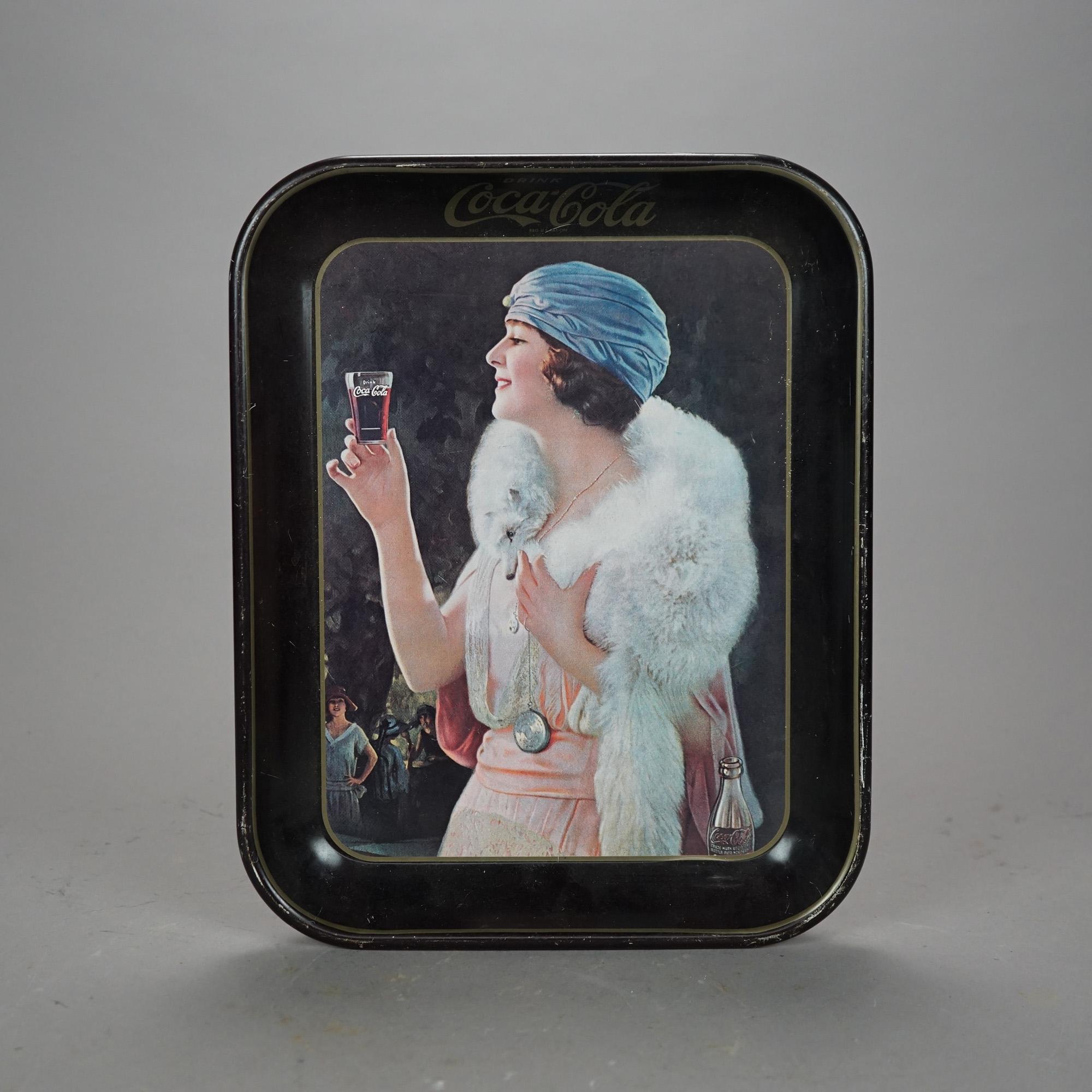 An vintage metal Coca-Cola advertising tray offers metal construction with woman with glass of coke, 20th century.

Measures- 1.25''H x 10.5''W x 13.5''D.

Catalogue Note: Ask about DISCOUNTED DELIVERY RATES available to most regions within 1,500