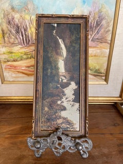 Vintage Tinted Landscape Photograph of Waterfall and Stone Bridge in Ornate