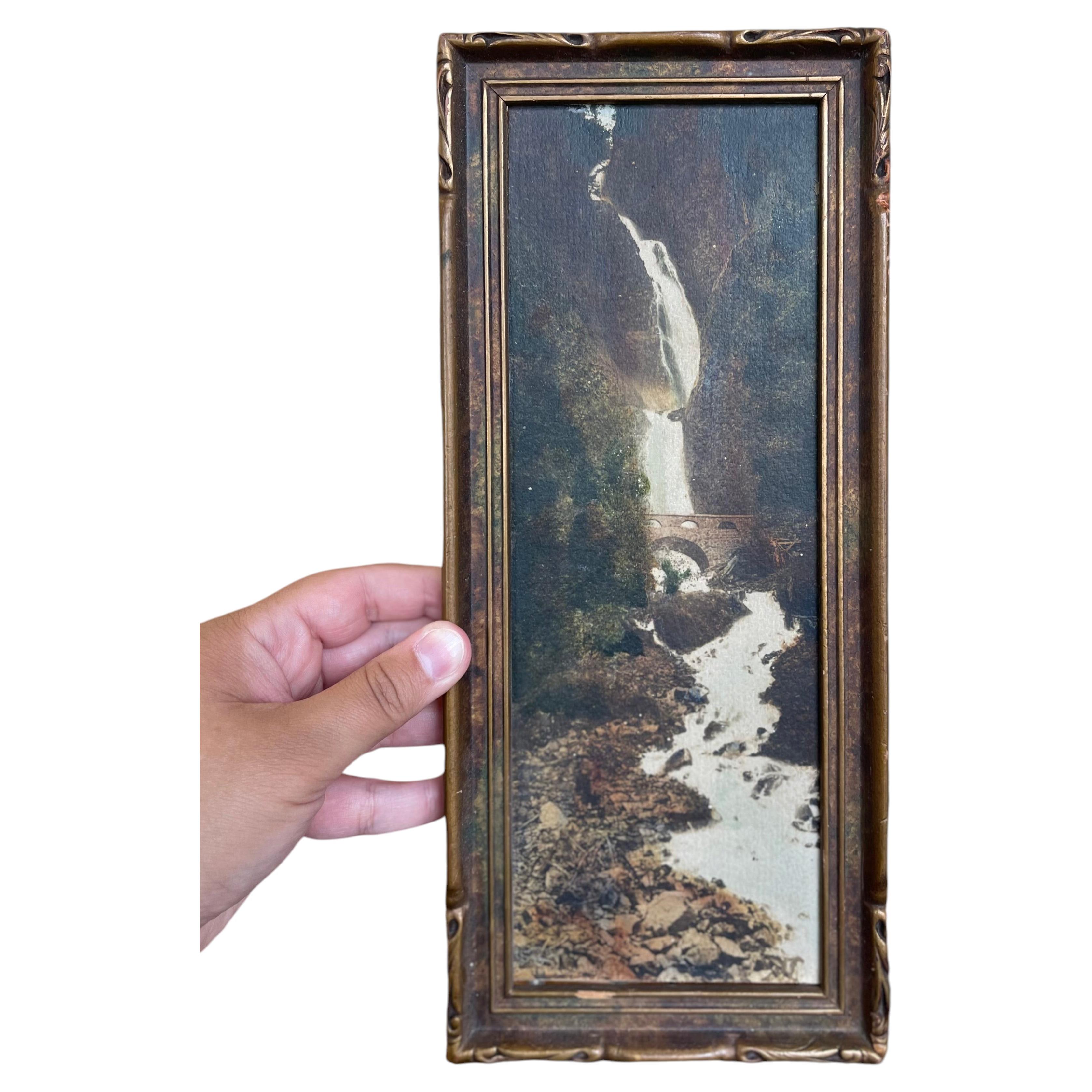 Vintage Tinted Landscape Photograph of Waterfall and Stone Bridge in Ornate