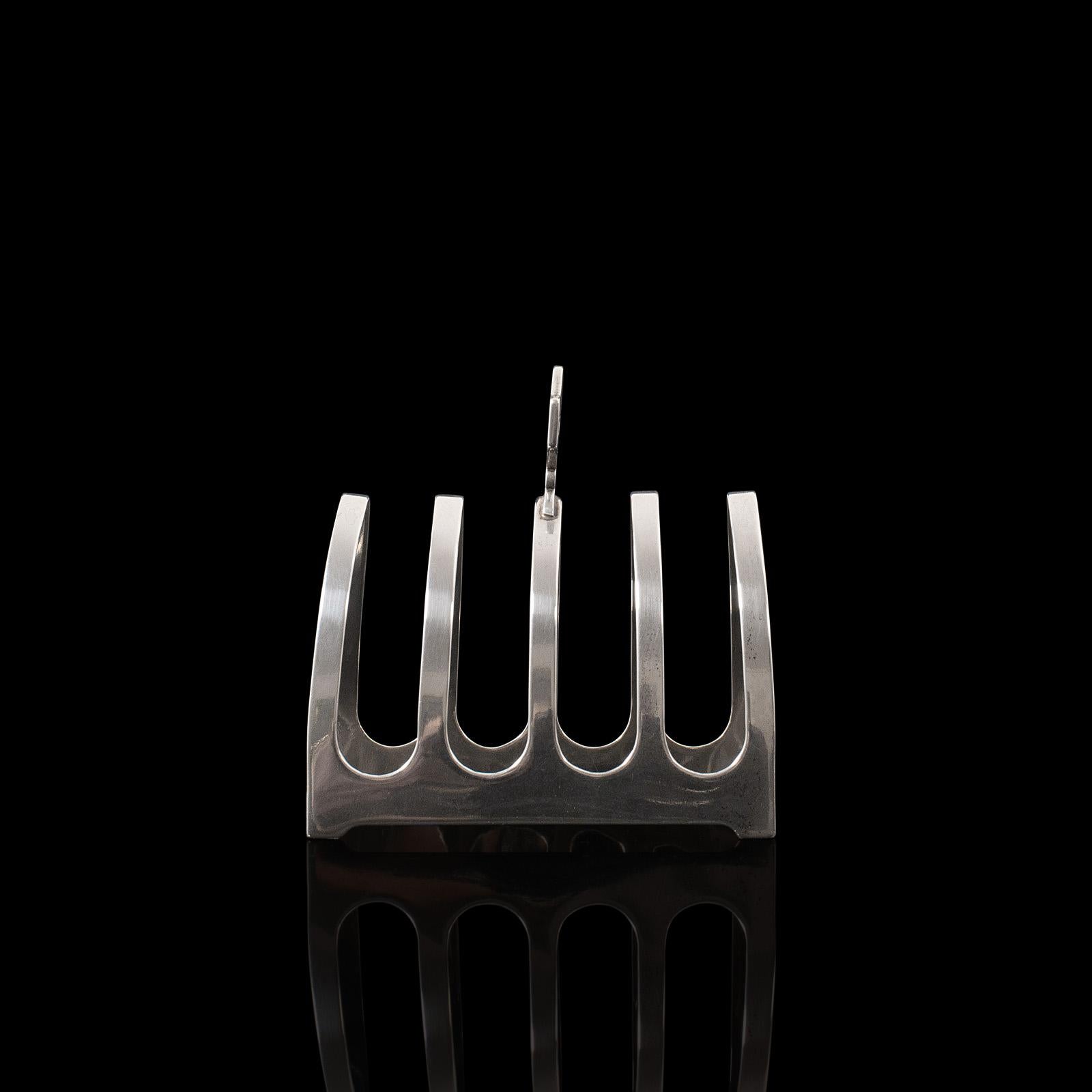 This is a vintage toast rack. An English, silver breakfast stand with hallmarks for Viners of Sheffield, dating to 1932.

Pleasingly petite, stylish table rack
Displaying a desirable aged patina with minimal tarnish present
Hallmarked silver