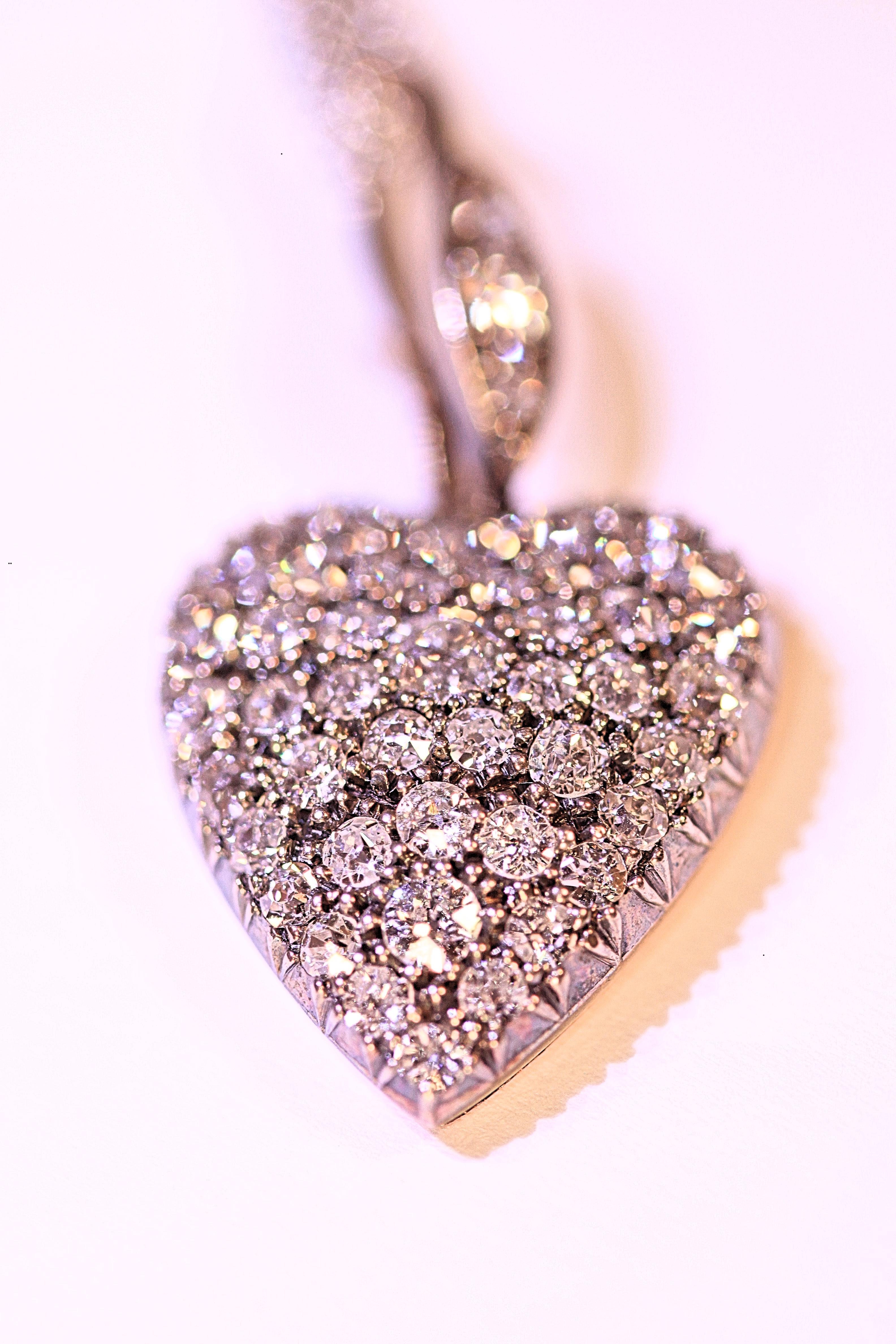 An amazing diamond locket with an approximate 3.20 carats total weight of old European/mine cut diamonds. The diamonds are F-G in color and VS2-SI1 in clarity.  The pendant is 14 karat white gold and rose gold on the back with black rhodium plating